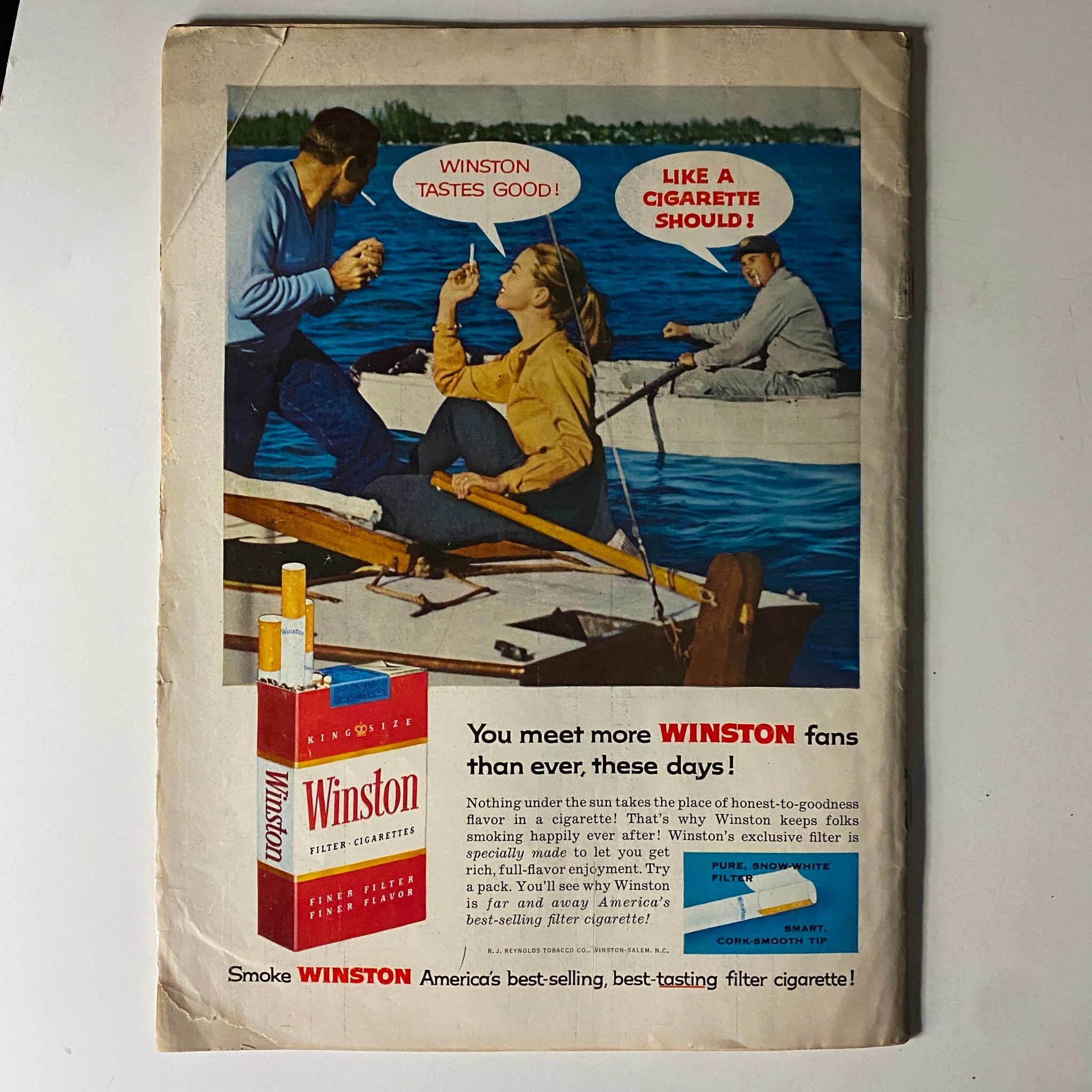 Advertisement for Winston cigarettes from The American Legion Magazine June 1957, showcasing people enjoying the outdoors while promoting Winston's tagline 'Winston tastes good!'