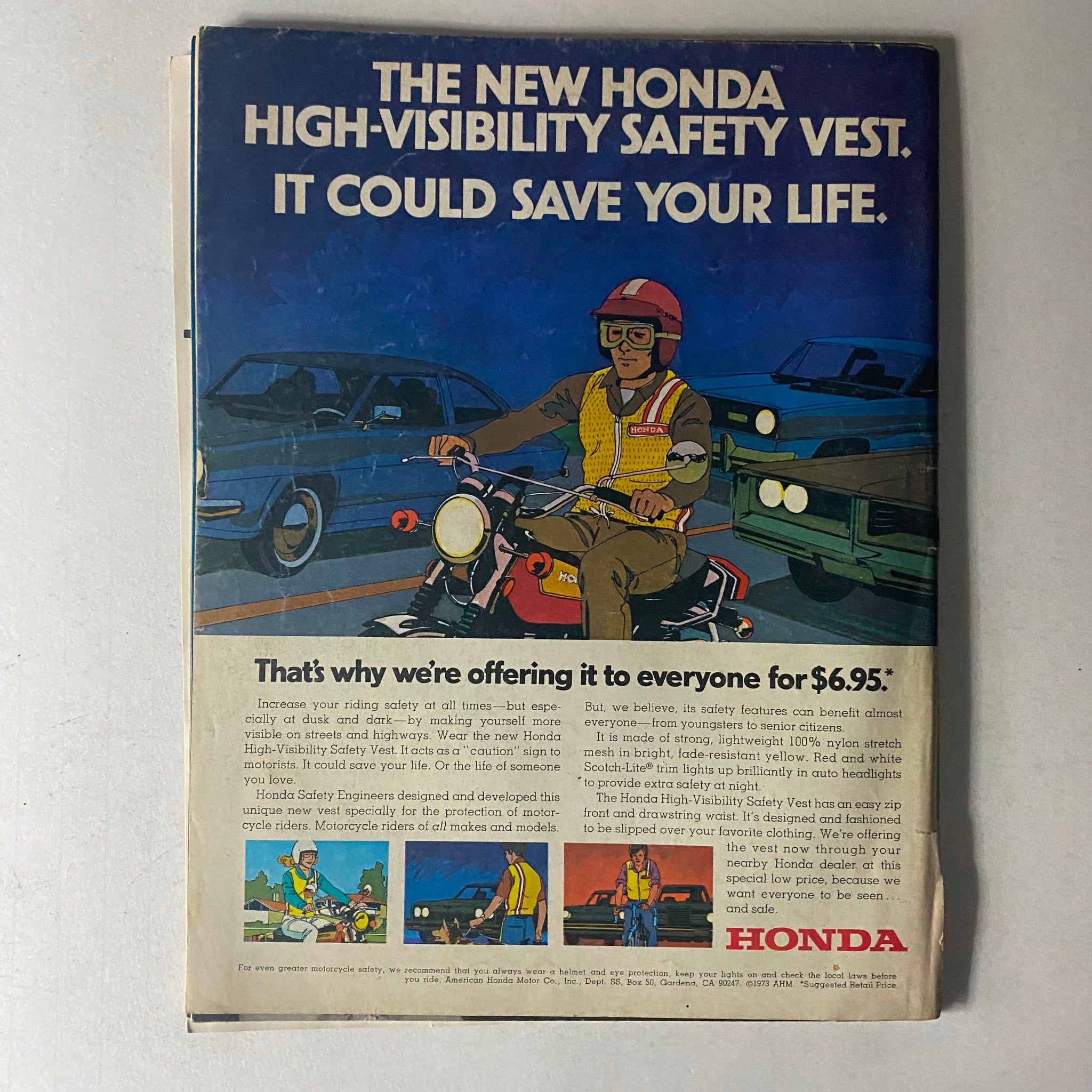 Vintage advertisement for the Honda High-Visibility Safety Vest, promoting motorcycle safety gear. Featured in the November 1973 issue of Motorcyclist Magazine, the ad showcases a motorcyclist wearing the vest, emphasizing safety while riding. This collectible magazine focuses on the Penton 175 Jackpiner and captures the motorcycle culture of the 1970s.