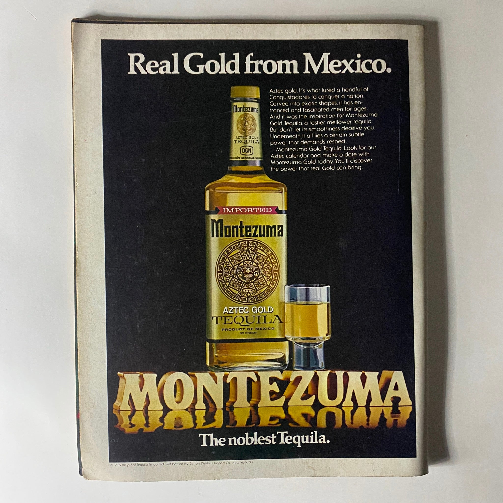 Vintage advertisement for Montezuma Aztec Gold Tequila featured in Club International Magazine June 1980. The ad highlights the luxurious appeal of the tequila with an image of the bottle and a shot glass. Text emphasizes its quality and heritage as 'The noblest Tequila.'