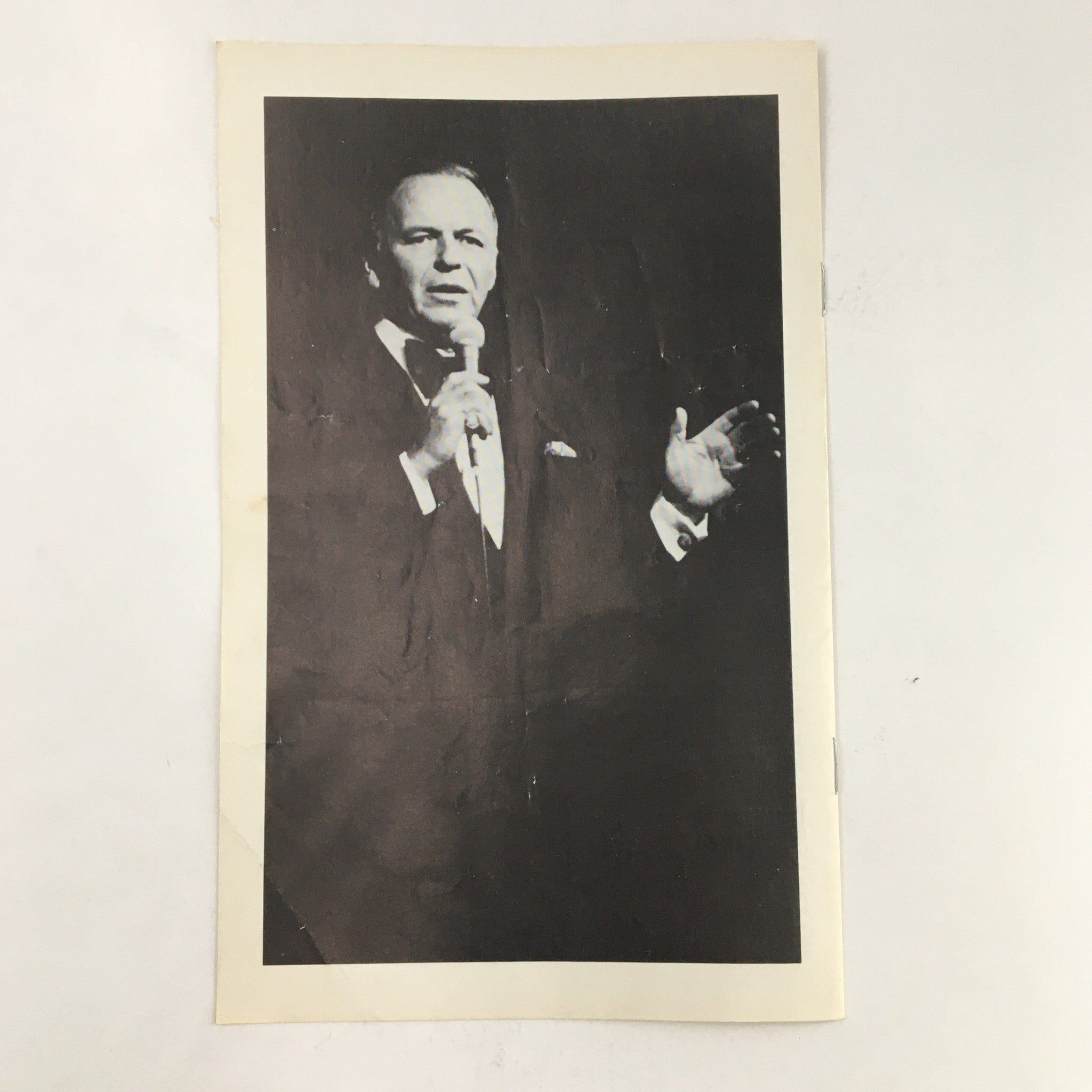 Another black and white image from the 1978 Playbill Radio City Music Hall Present Intermission of Frank Sinatra, showing Sinatra gesturing passionately while holding a microphone, capturing his artistic presence.