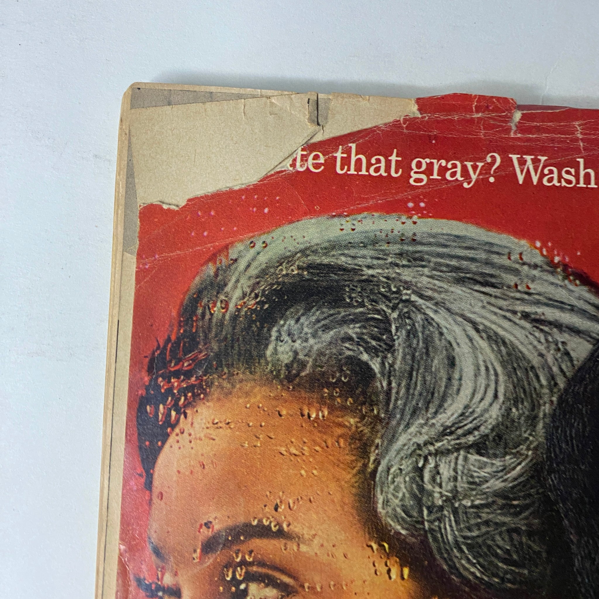 Ebony Magazine May 1965 cover detail showing aged edges, featuring a model with styled hair showcasing a product meant for hair care.