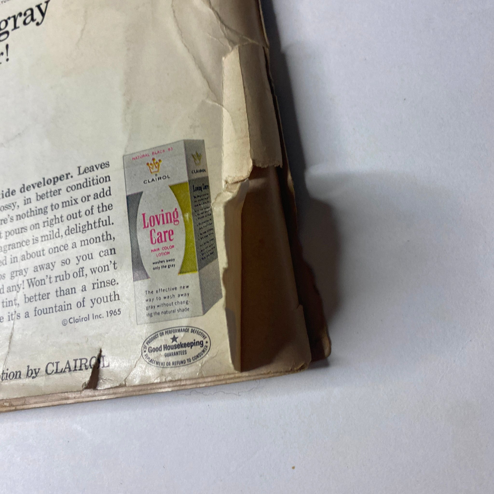 Back cover of Ebony Magazine May 1965 showcasing Clairol Loving Care hair color product advertisement for covering gray hair. Contains information about the product's application and benefits.