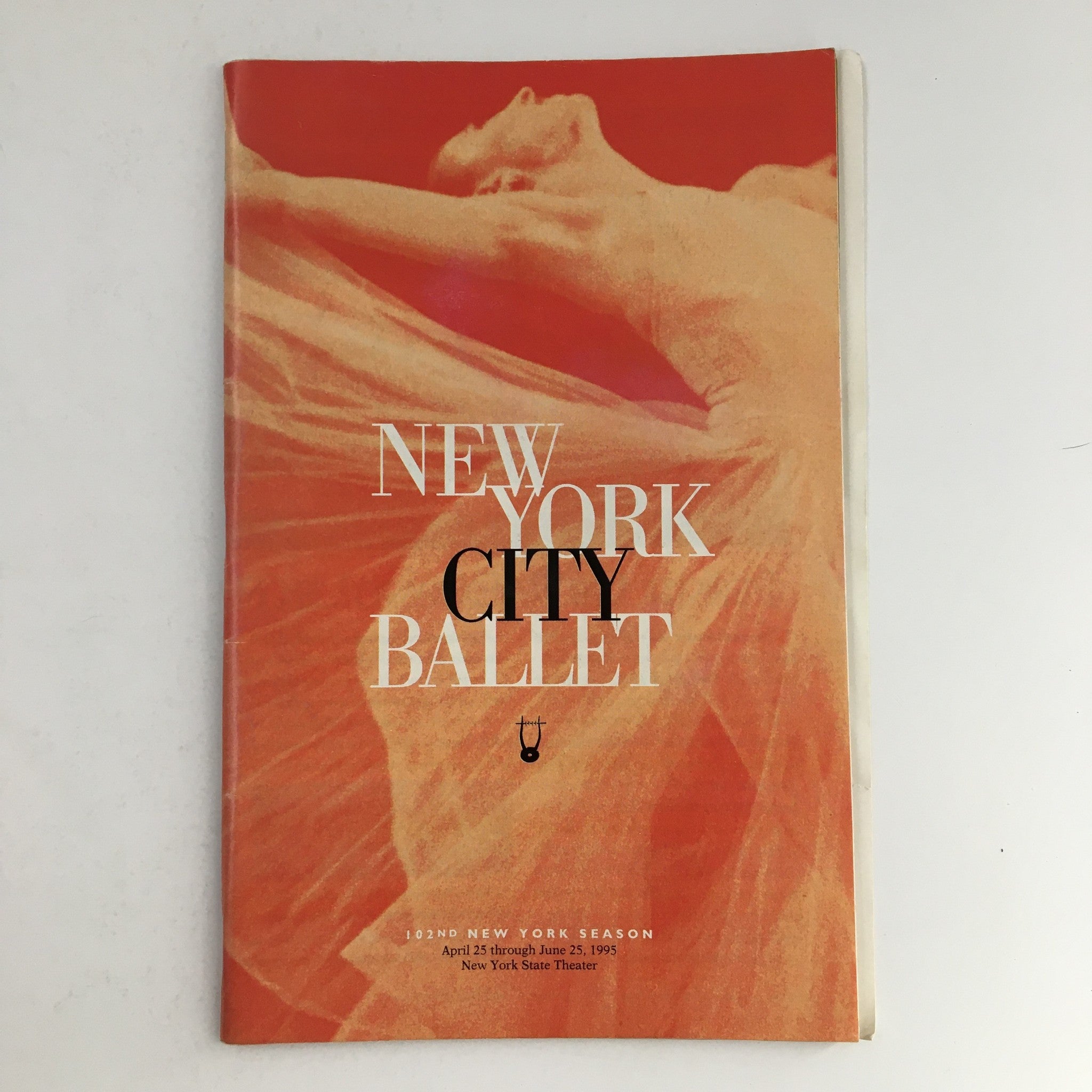 1995 Playbill for New York City Ballet, showcasing a stunning dance image with vibrant colors, presenting the 102nd New York Season at New York State Theater.