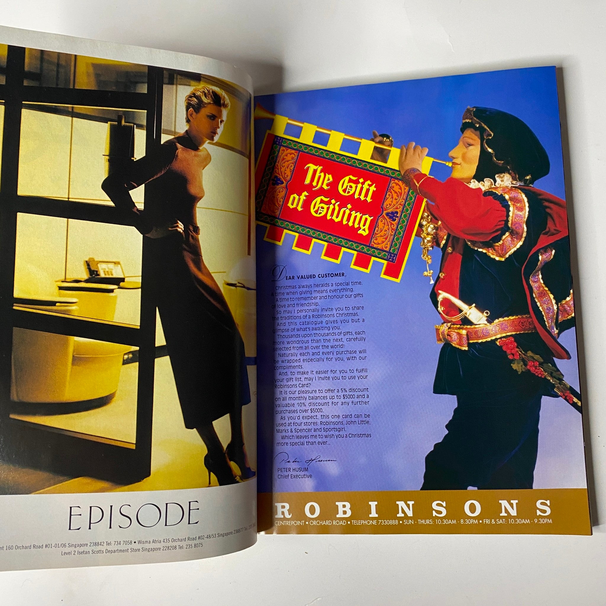 Fashion advertisement from Her World Magazine December 1997 showcasing a sophisticated attire and holiday gifting ideas.