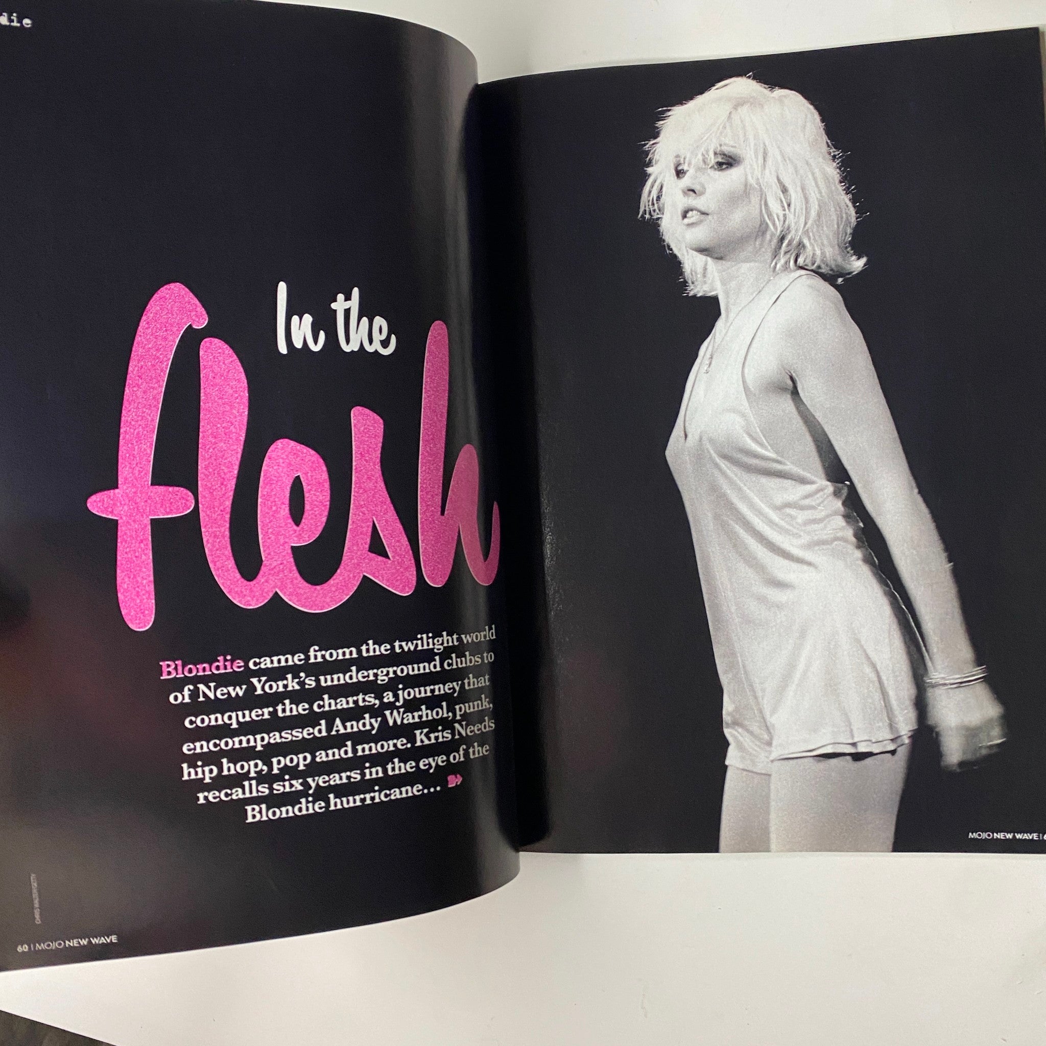 A striking black and white image from Mojo Classic Magazine, highlighting Blondie's influence on pop culture, titled 'In the Flesh', celebrating the band's journey.