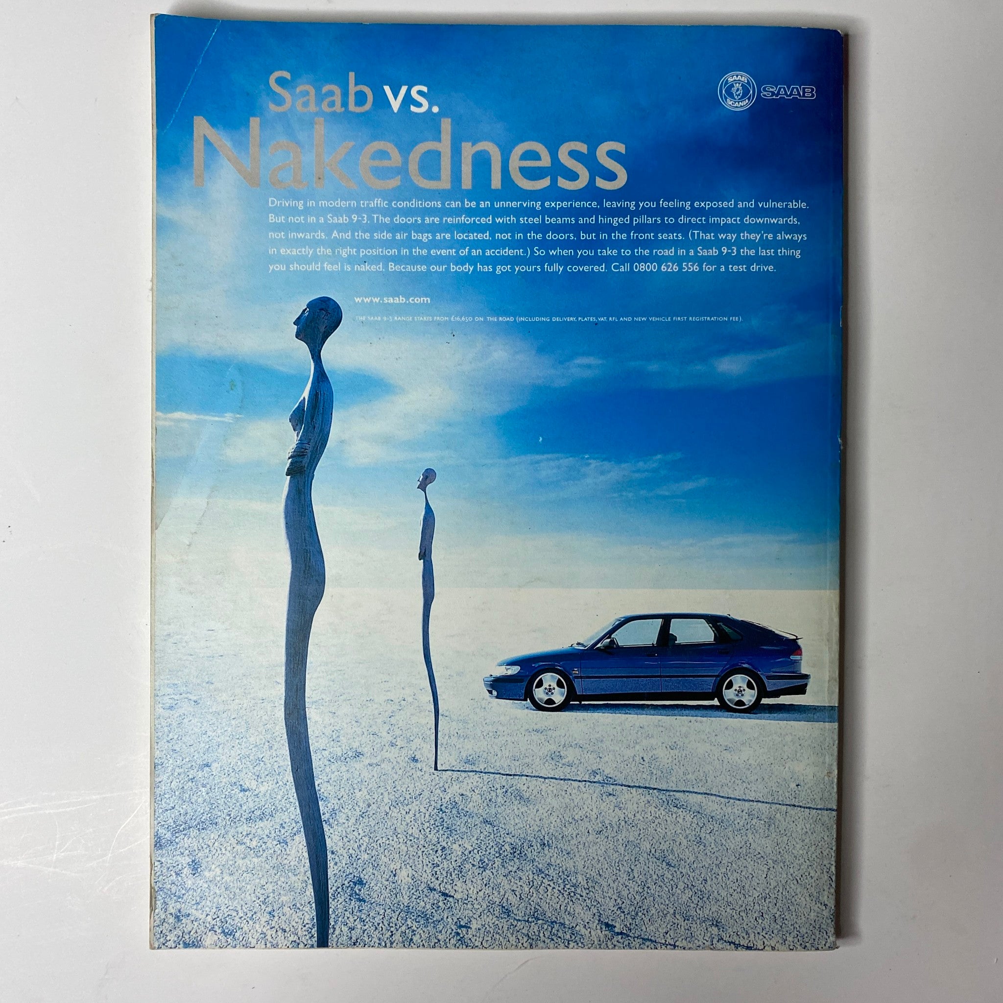 Mojo Music Magazine September 1999 advertisement for Saab vs. Nakedness, highlighting the car's design in a creative context.