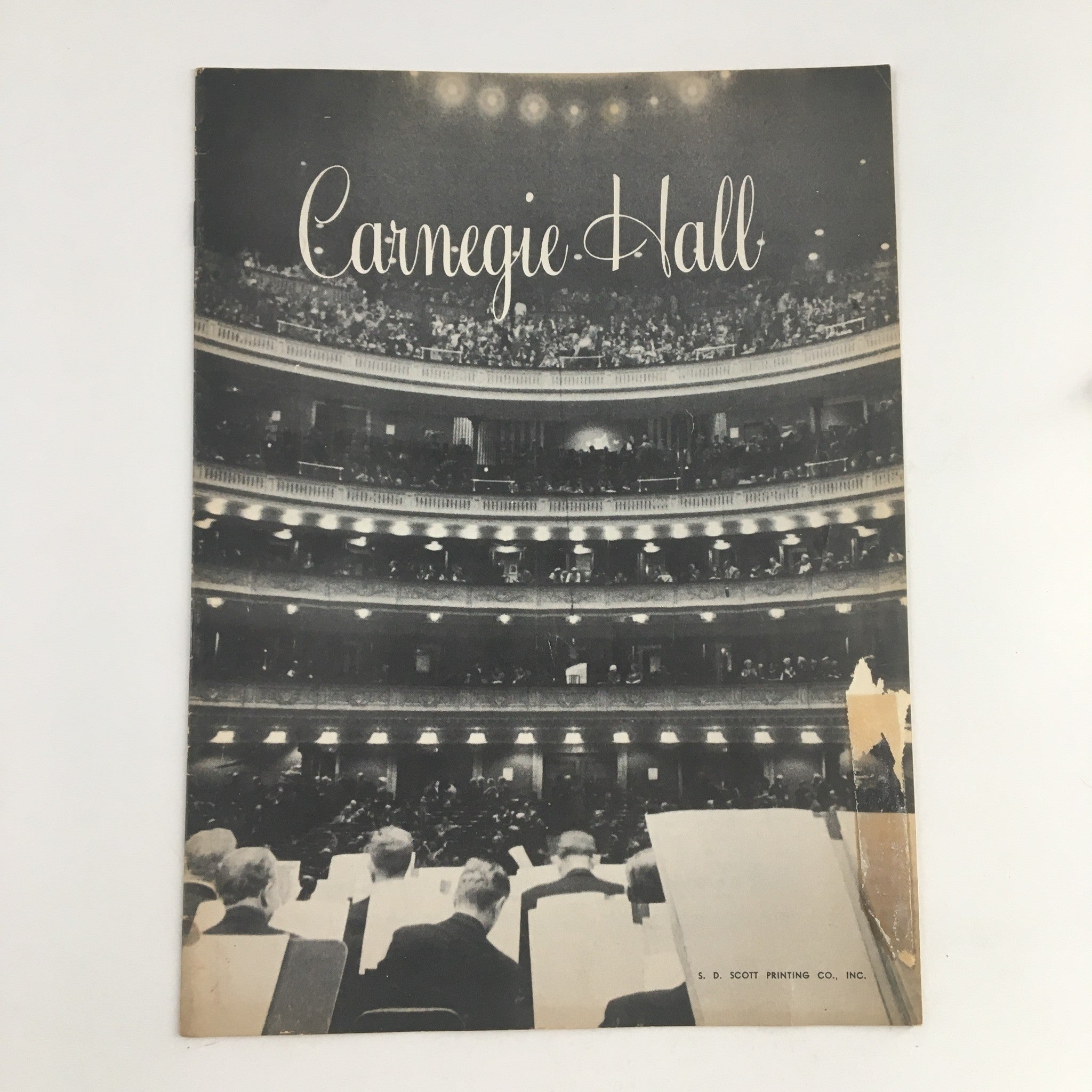 Vintage 1957 Carnegie Hall Program featuring a black and white image of the concert hall, showcasing the audience and orchestral seating, capturing the historical significance of Pianist Benno Moiseiwitsch and The Symphony of the Air.