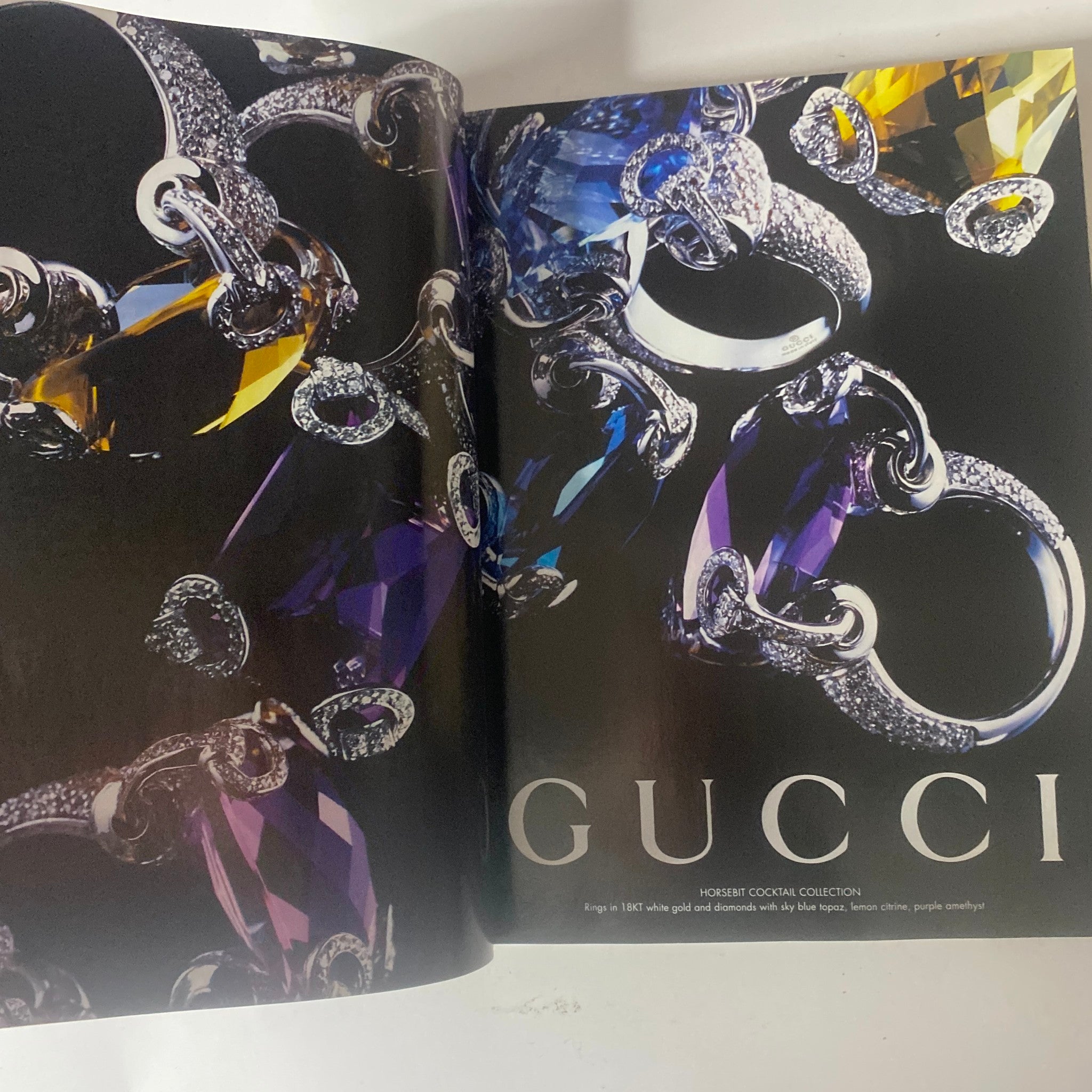 Feature in Vogue British Magazine December 2006 presenting Gucci's luxurious jewelry collection with vibrant gemstones.