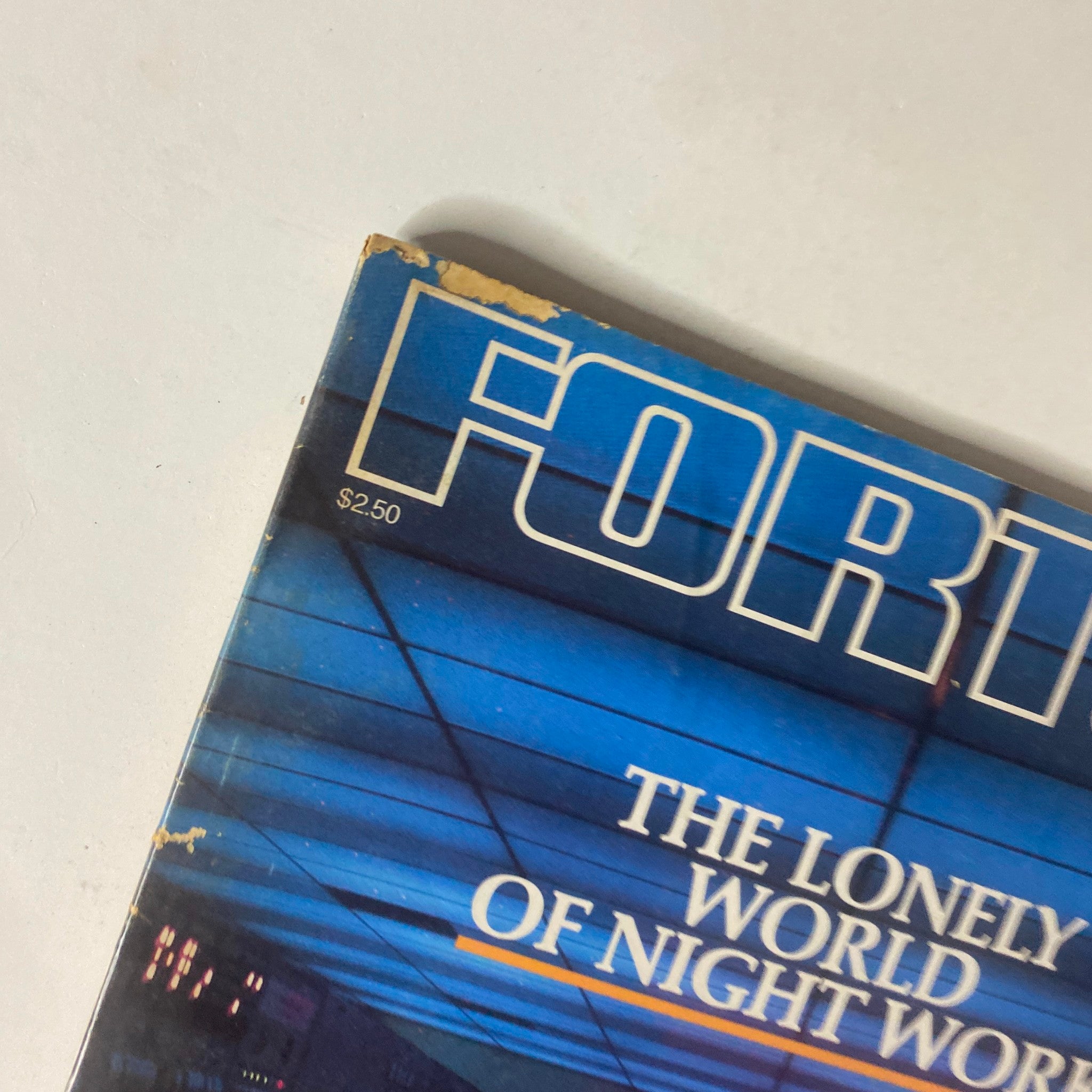 Close-up of Fortune Magazine December 15, 1980 cover highlighting the text 'THE LONELY WORLD OF NIGHT WORK' with blue background and details of edge wear.