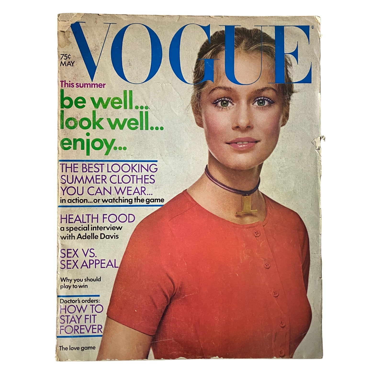 Vogue Magazine May 1971 featuring Lauren Hutton on the cover, showcasing a scarlet nylon T-shirt by Anne Klein, with a choker accessory, highlighting bold summer fashion and lifestyle trends.