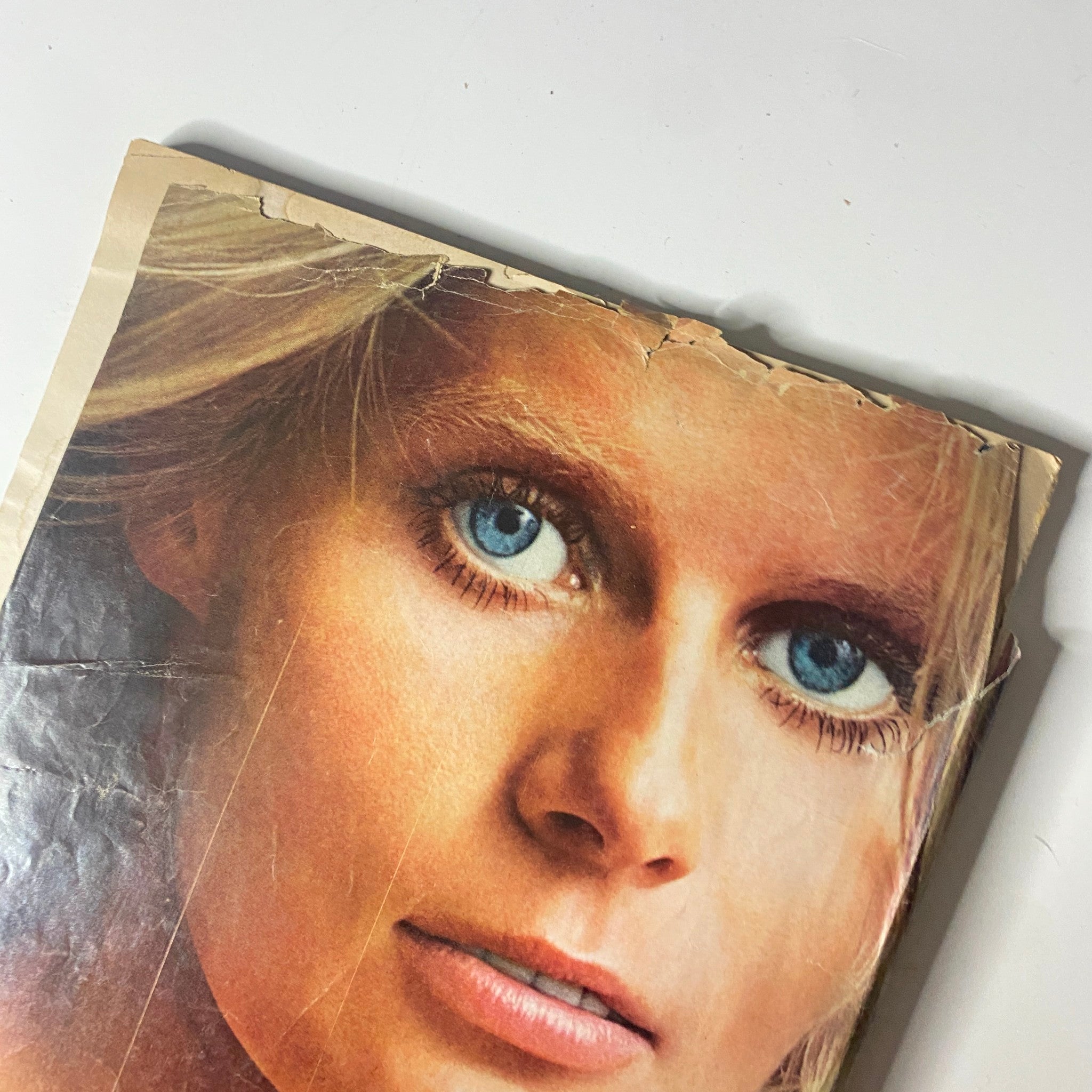 Close-up shot of a model's face from a skin care advertisement. The image features her striking blue eyes and natural beauty, emphasizing the message of authenticity in skin care from Vogue Magazine - November 1, 1971.