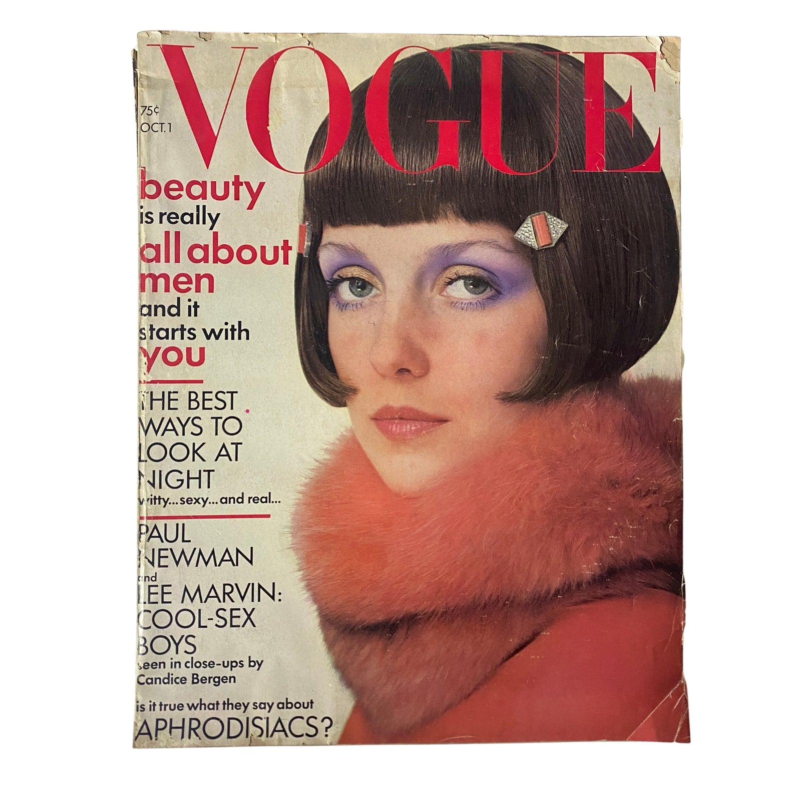 Cover of Vogue Magazine, October 1, 1971, featuring a model with a sleek bob haircut styled in a bold purple eye makeup and a luxurious red fox wrap, embodying fashion elegance and beauty.