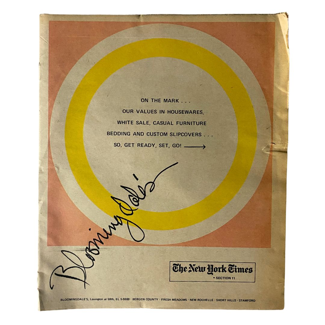 Cover of The New York Times Magazine Bloomingdale's No Label featuring a circular design in orange, yellow, and white with text promoting housewares and furniture.