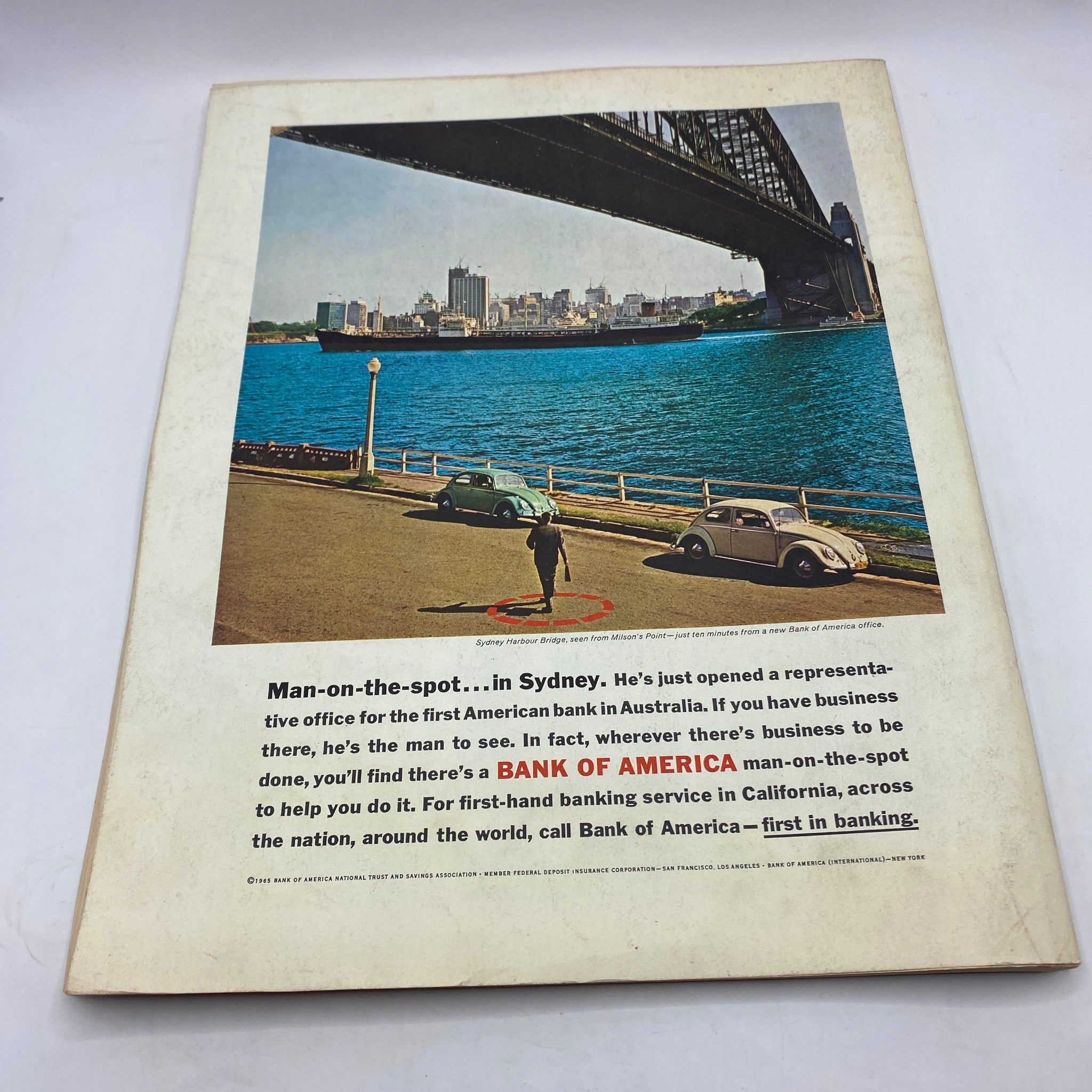 Back cover of VTG Fortune Magazine May 1965 featuring a vibrant image of Sydney Harbour Bridge and an advertisement for Bank of America, emphasizing global banking services.