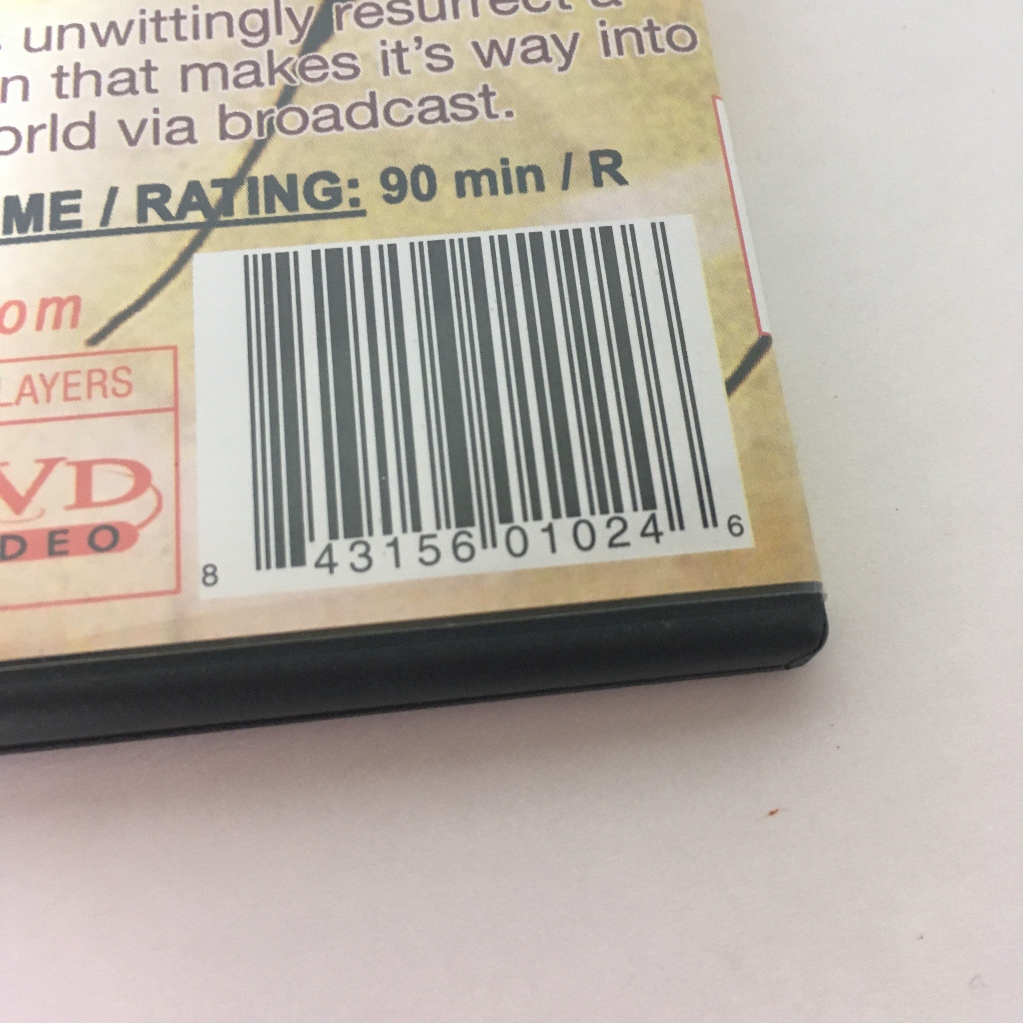 Detailed view of the Demons/Demons 2 Double Feature DVD's barcode and rating, indicating a runtime of 90 minutes and an R rating for horror content.