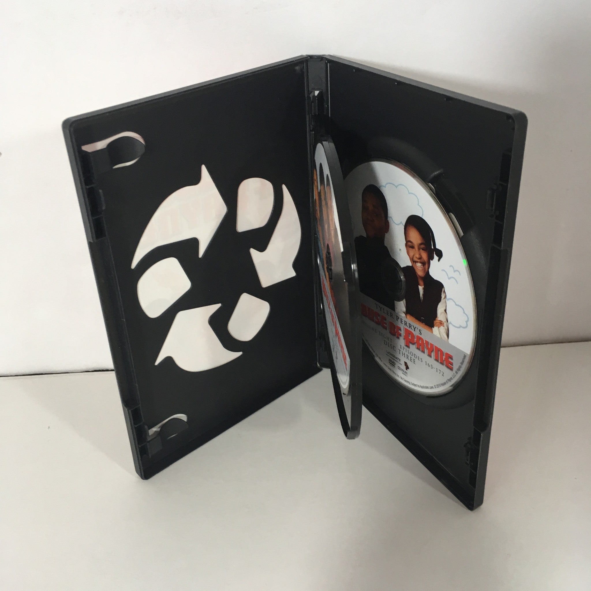 Inside view of Tyler Perry's House of Payne, Vol. 8 DVD case with a CD visible, highlighting the disc artwork and reusable disc holder.