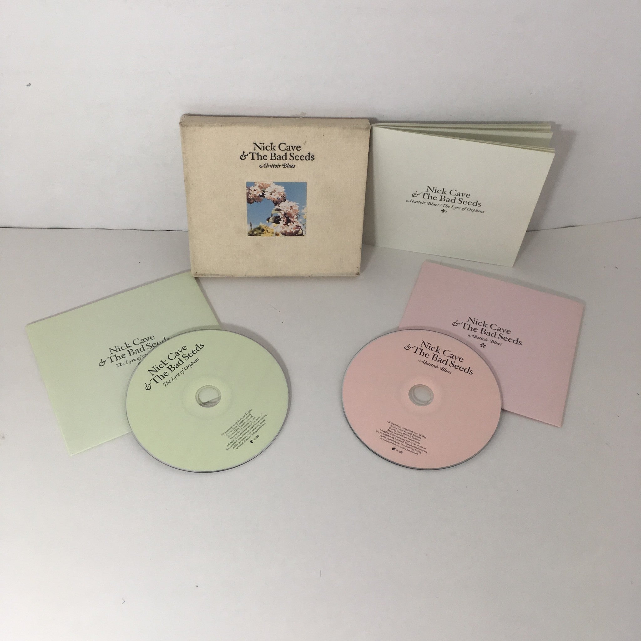 Inside view of Abattoir Blues/The Lyre of Orpheus Nick Cave & The Bad Seeds 2 Disc Set Audio CD with two discs displayed alongside the album packaging.