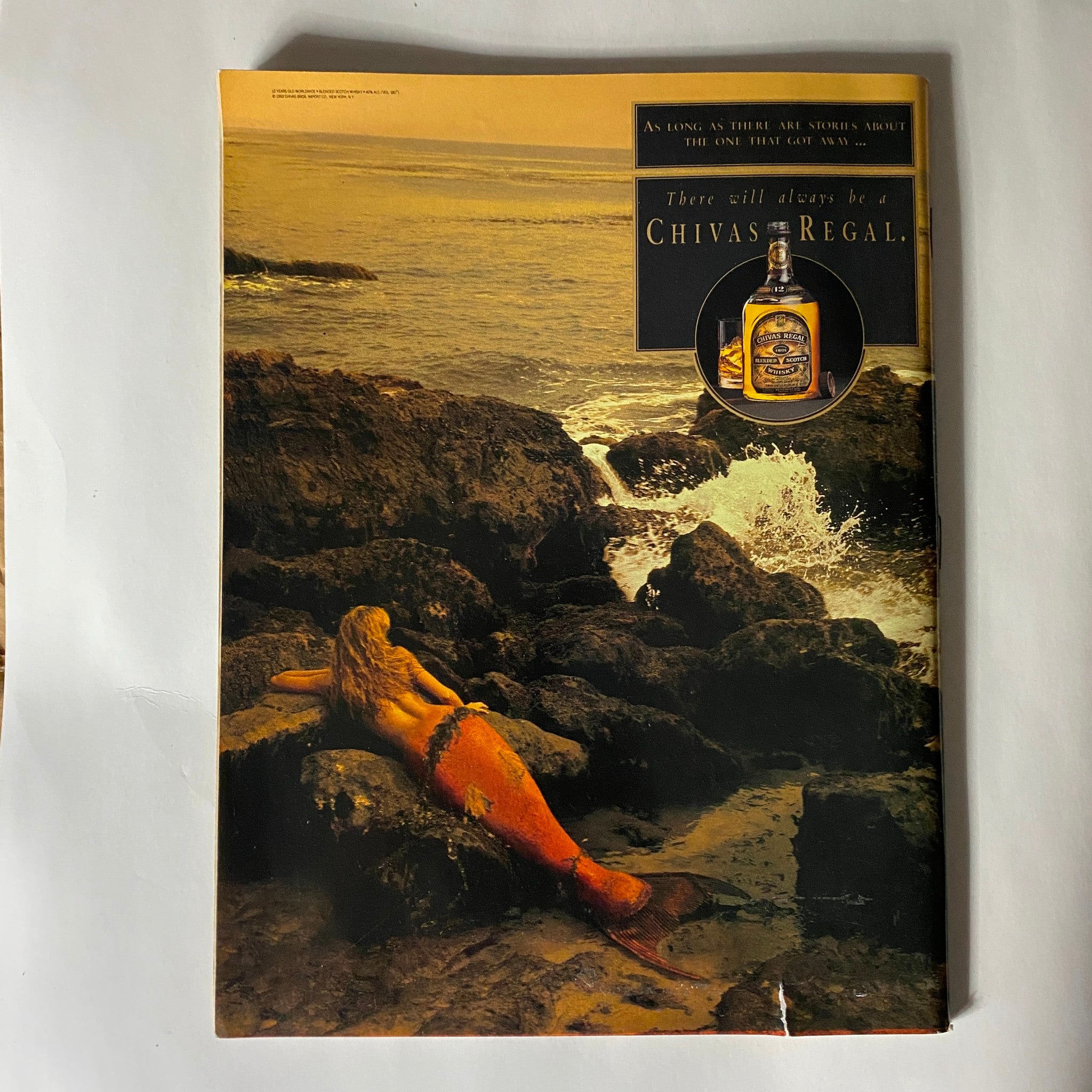Full-page Chivas Regal advertisement from Sports Illustrated Magazine 1993, depicting a mermaid lounging on rocks with scenic coastal imagery.