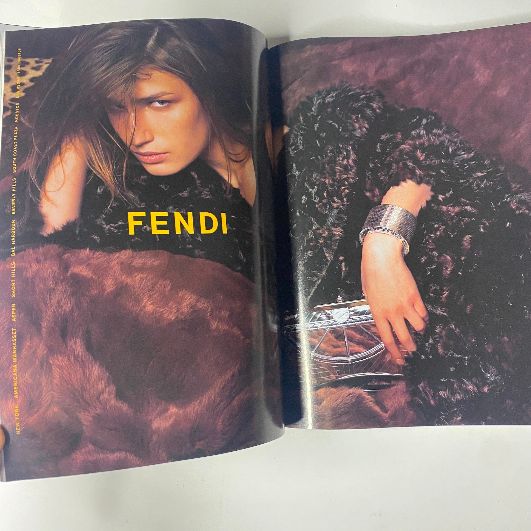 Fendi advertisement from Vogue Magazine October 2004, featuring a model styled with luxurious fur and accessories, representing high fashion.