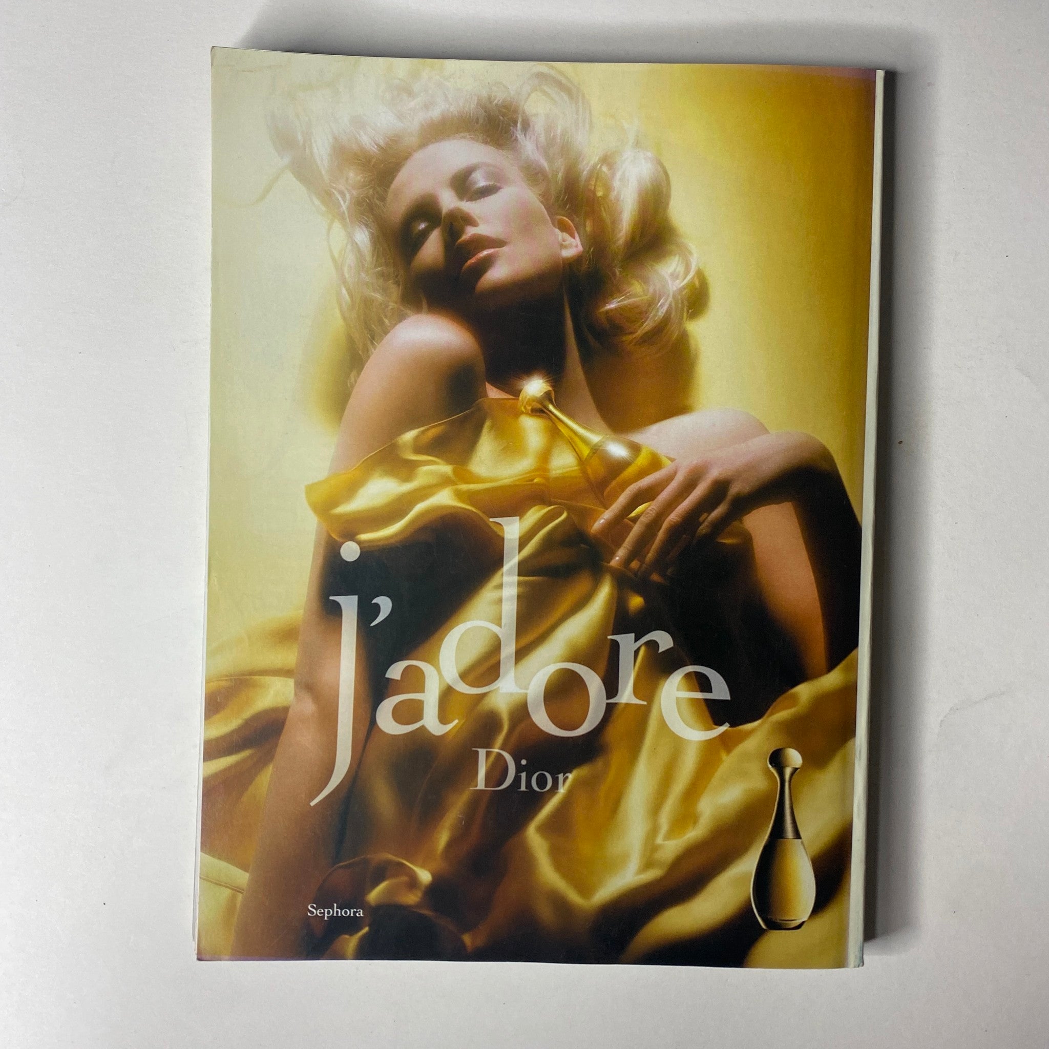 Dior fragrance advertisement from Vogue Magazine October 2004, showcasing J'adore in a glamorous, golden-themed layout with a model.