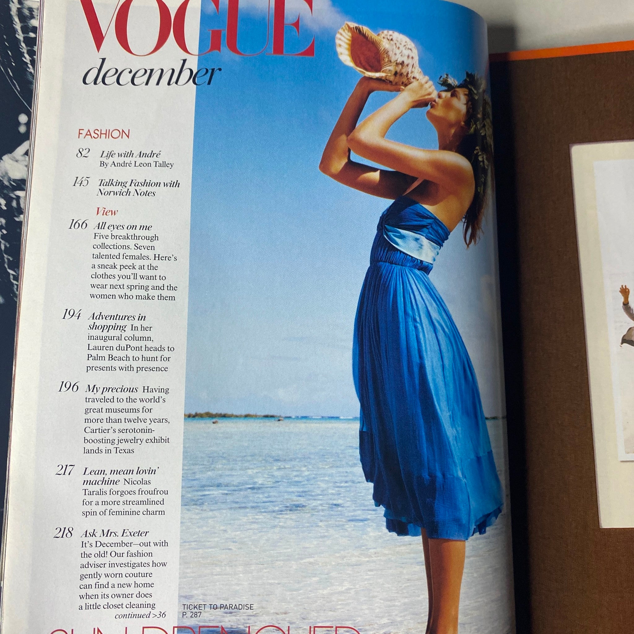 Inside spread of Vogue Magazine December 2004, showcasing a fashion editorial featuring a model in a blue dress, with article headings visible.
