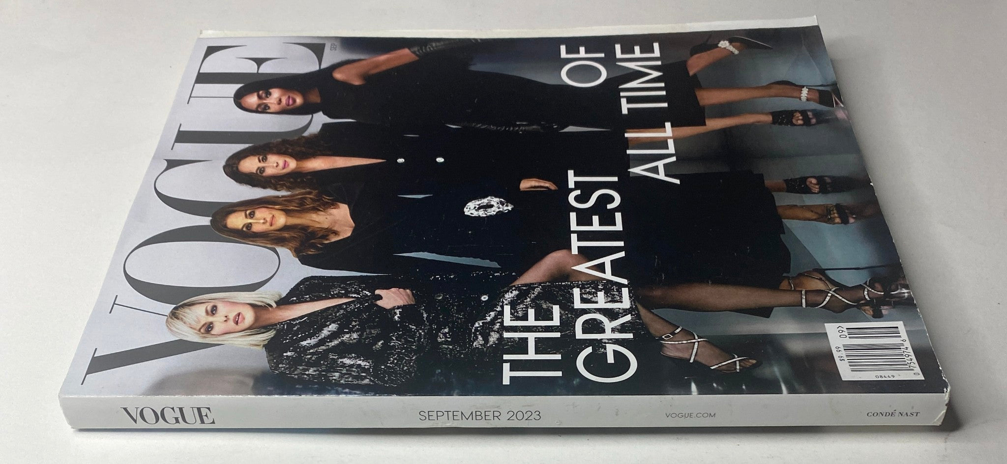 Side view of Vogue Magazine September 2023, showcasing the iconic cover with supermodels in elegant attire, entitled 'The Greatest of All Time.'