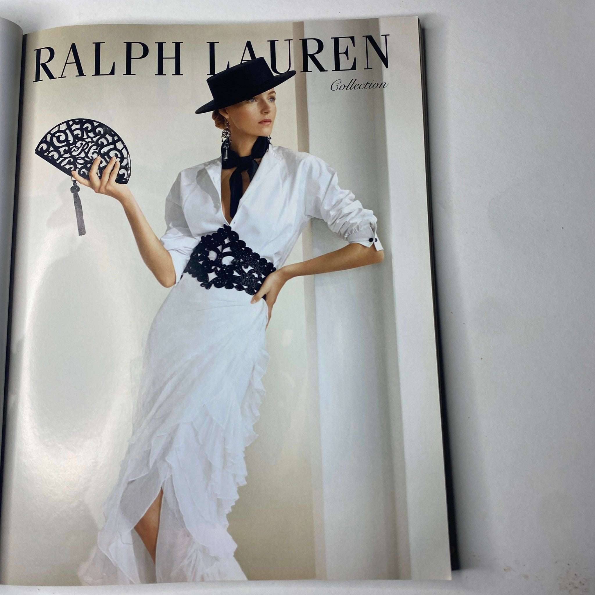 Vogue Paris Magazine February 2013 No. 934 featuring a RALPH LAUREN Collection fashion spread, showcasing a model in an elegant white dress with ruffles, holding a decorative clutch.