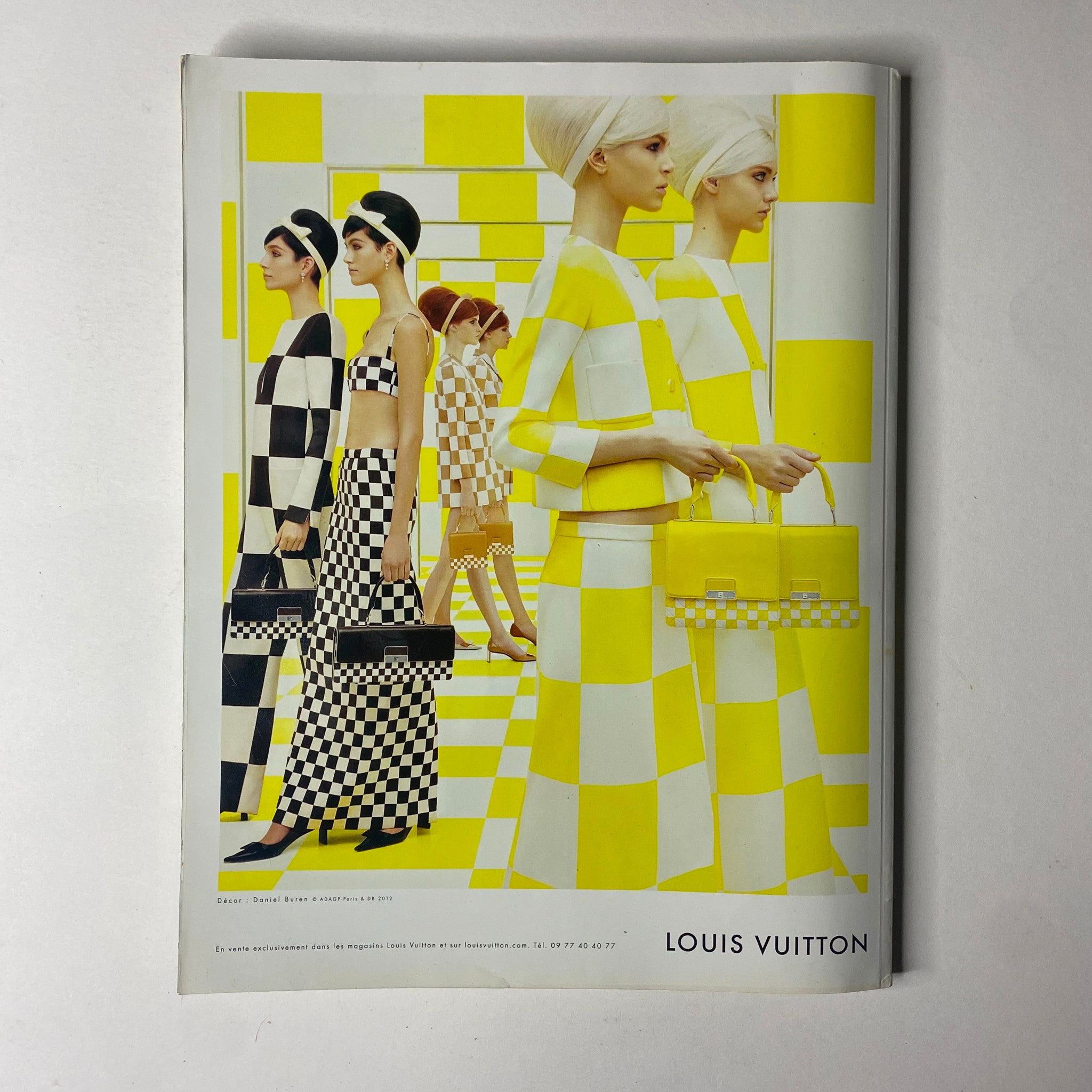 Vogue Paris Magazine February 2013 No. 934 features a striking Louis Vuitton advertisement, showcasing models in vibrant yellow and checkered patterns, embodying high-fashion trends.