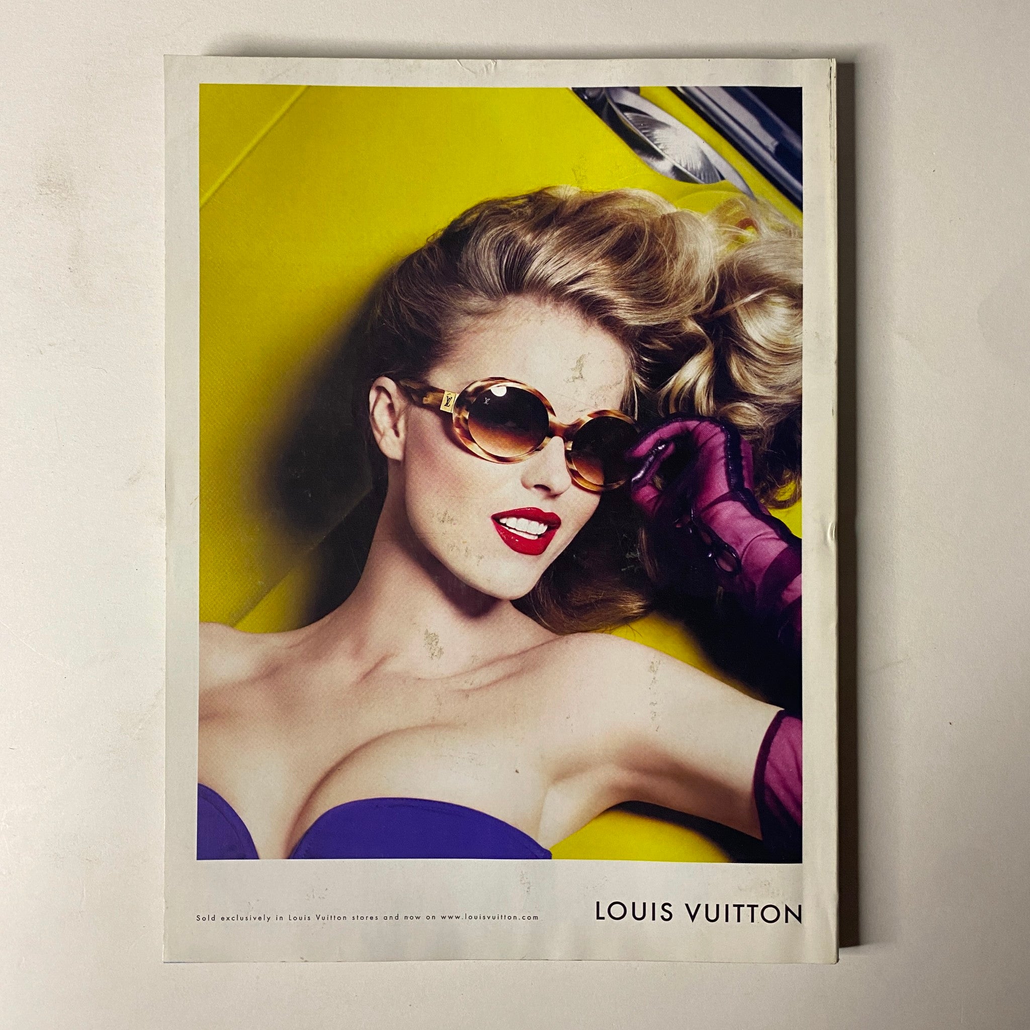 Vogue Magazine July 2008 featuring a Louis Vuitton advertisement with a glamorous model wearing stylish sunglasses against a bold yellow backdrop.