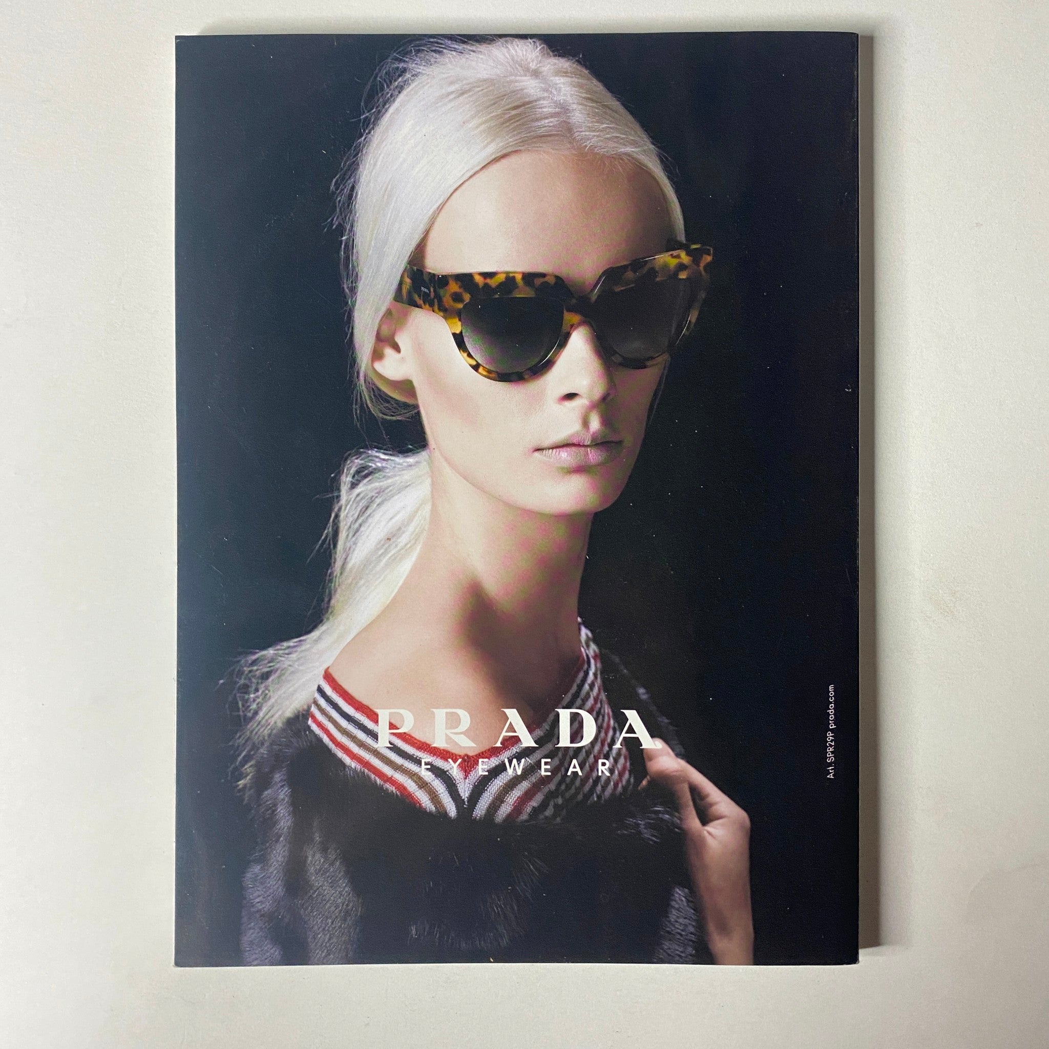 A Prada eyewear advertisement from Vogue Magazine June 2013 featuring a model wearing stylish sunglasses, highlighting the latest trends in fashion accessories.
