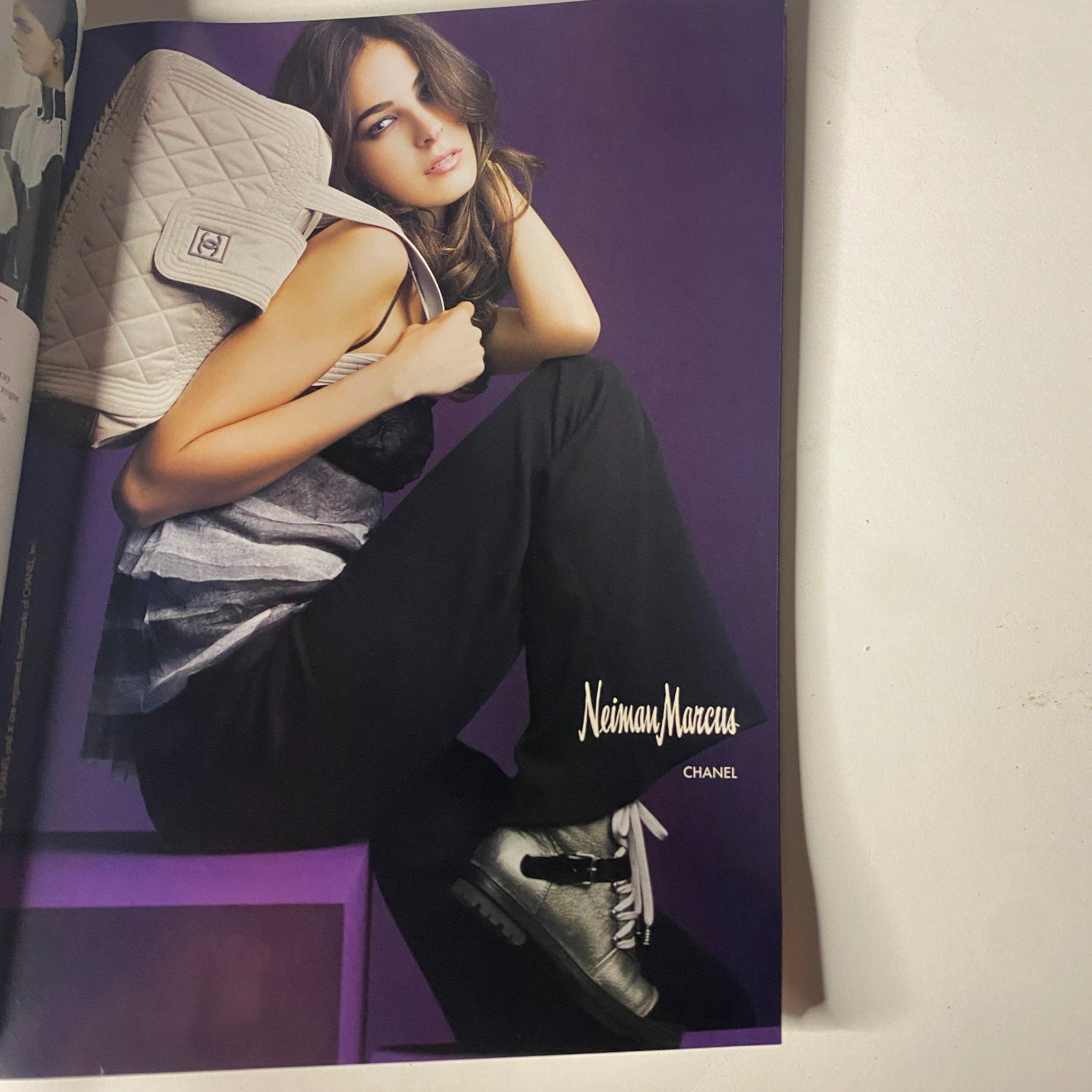 Chanel advertisement featured in Vogue Magazine August 2005, presenting a stylish model in upscale fashion attire with a chic handbag.
