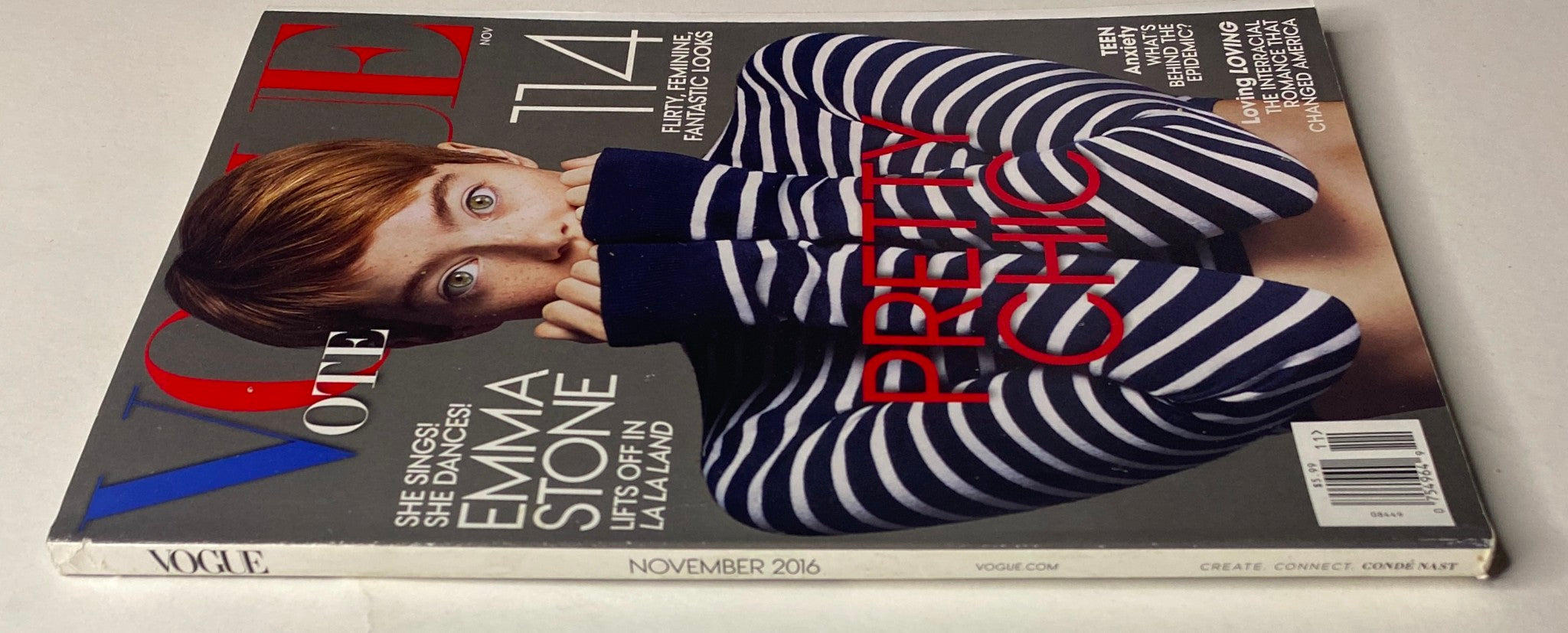 Side view of Vogue Magazine November 2016 with Emma Stone on the cover, showcasing the stylish striped design and the text 'Pretty Chic' prominently displayed.