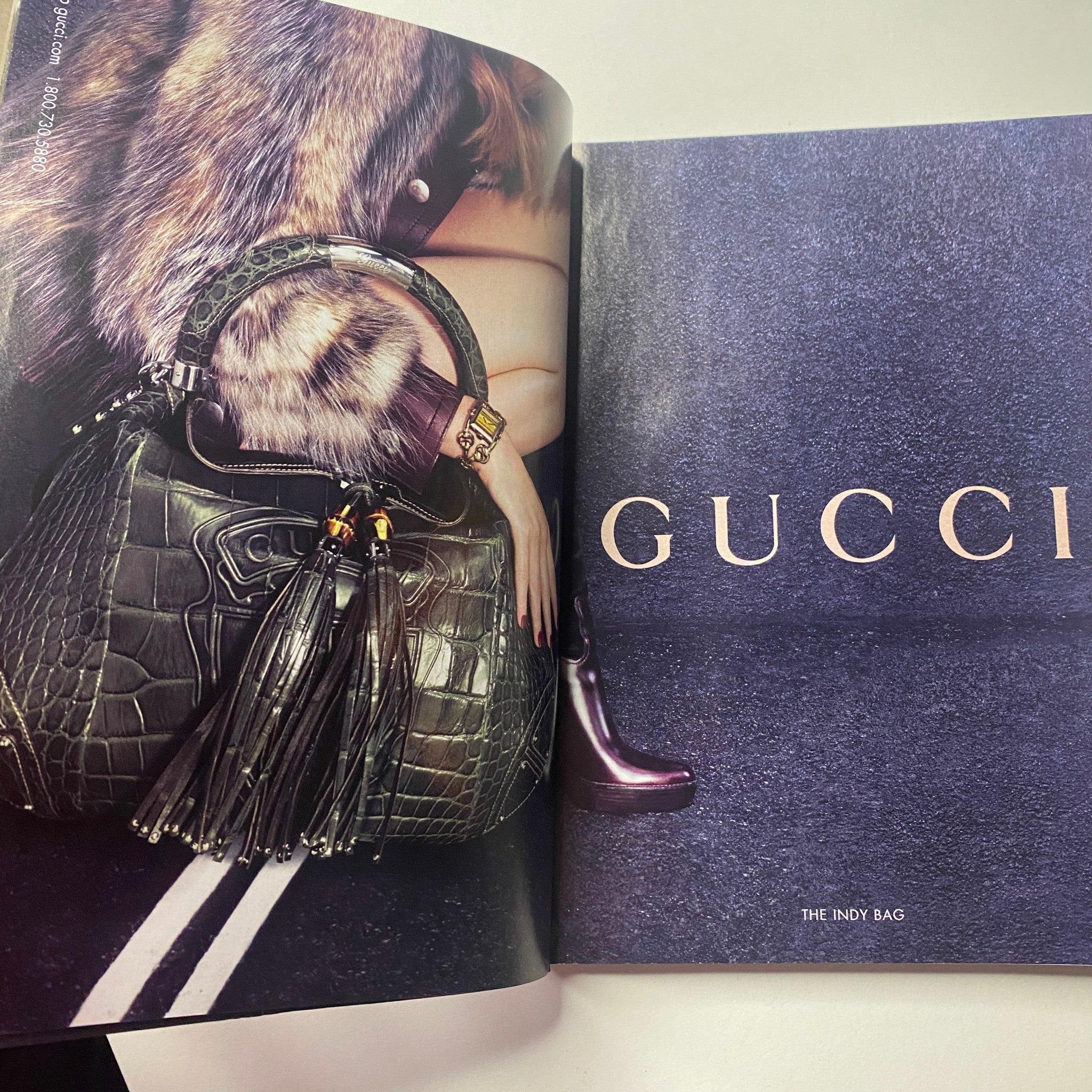 Gucci advertisement showcasing the Indy Bag, featuring chic accessories and a fashionable model, from Vogue Magazine August 2007 with Winona Ryder on the cover.