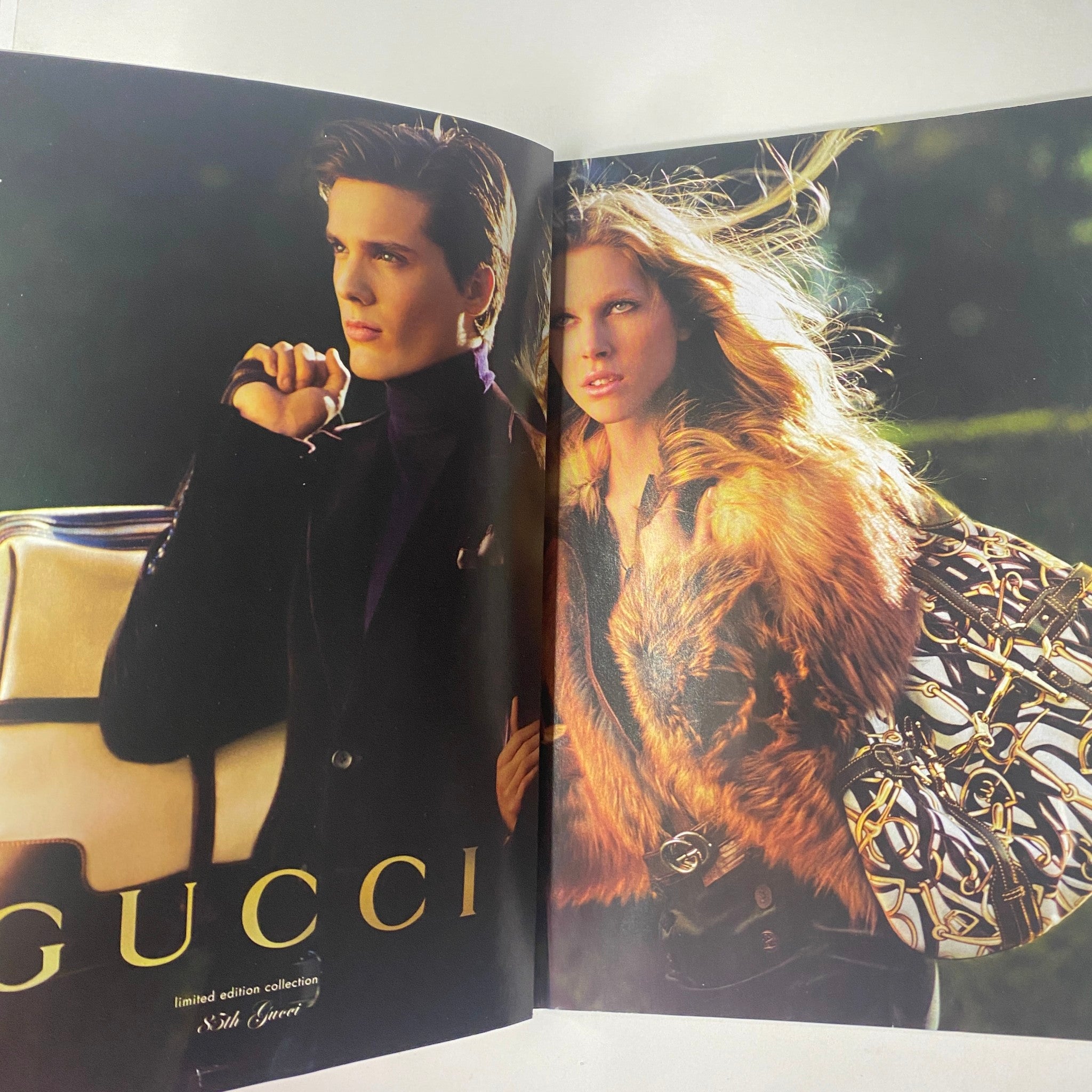 Advertisement in Vogue Magazine July 2006 for Gucci, featuring a model in a stylish fur coat and limited edition accessories.