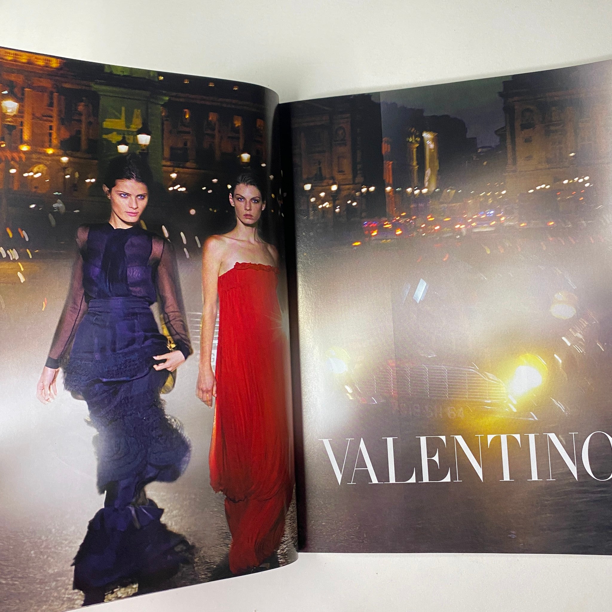 Vogue Magazine October 2008 featuring a high-fashion spread with models in elegant dresses on a city street at night with the word 'VALENTINO' prominently displayed.