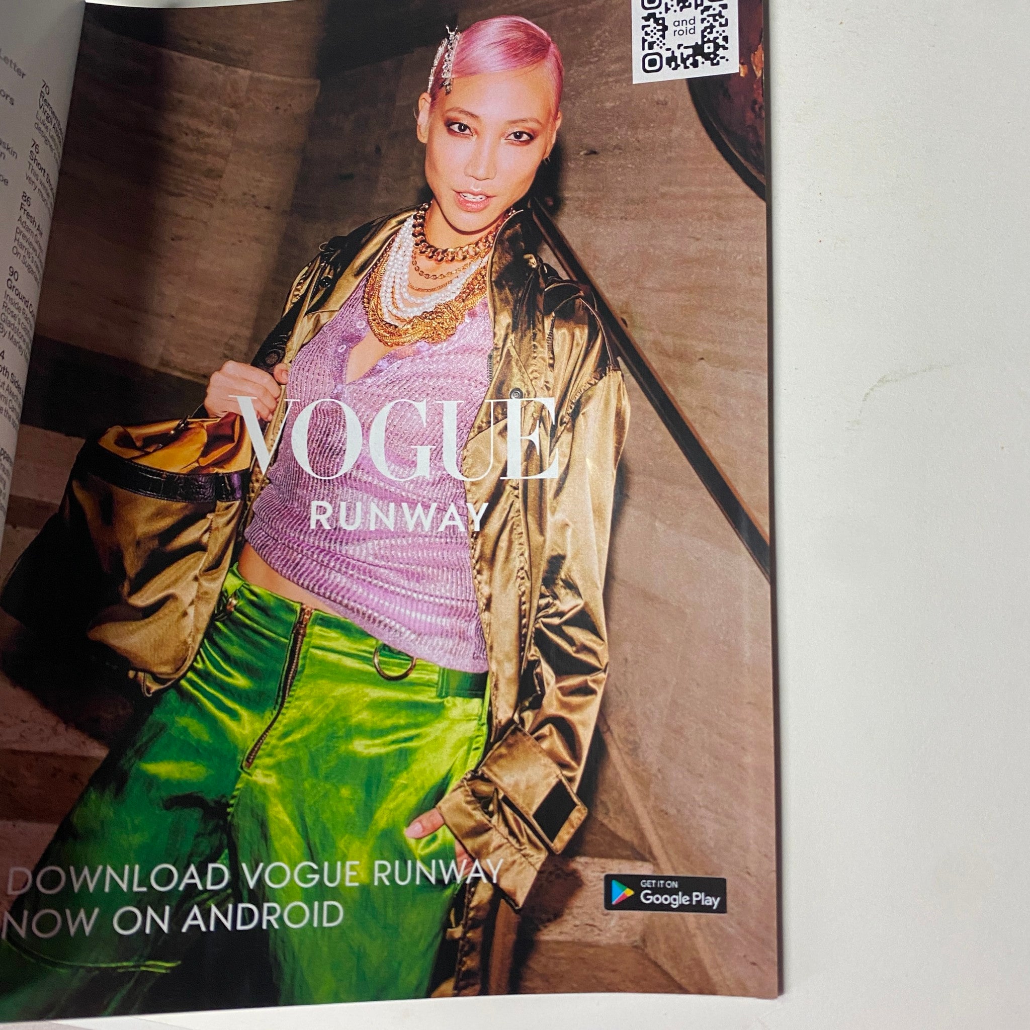 Advertisement page from Vogue Magazine February 2022, promoting Vogue Runway app with a fashion-focused image.