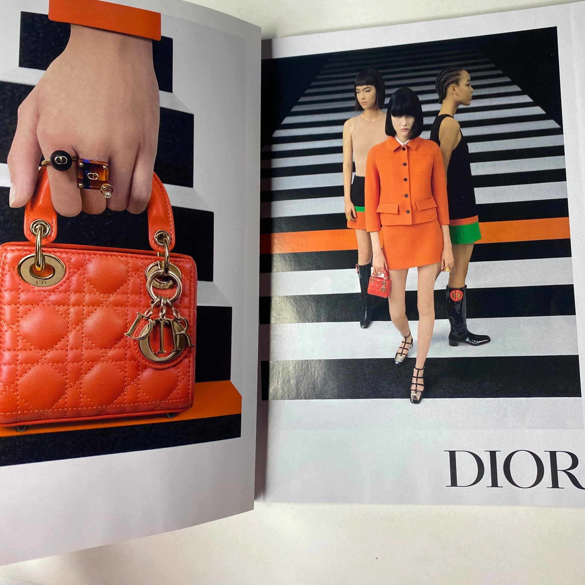 Vogue Magazine February 2022 featuring a high-fashion editorial spread with models in striking outfits and accessories from Dior, showcasing bold colors and contemporary styles.