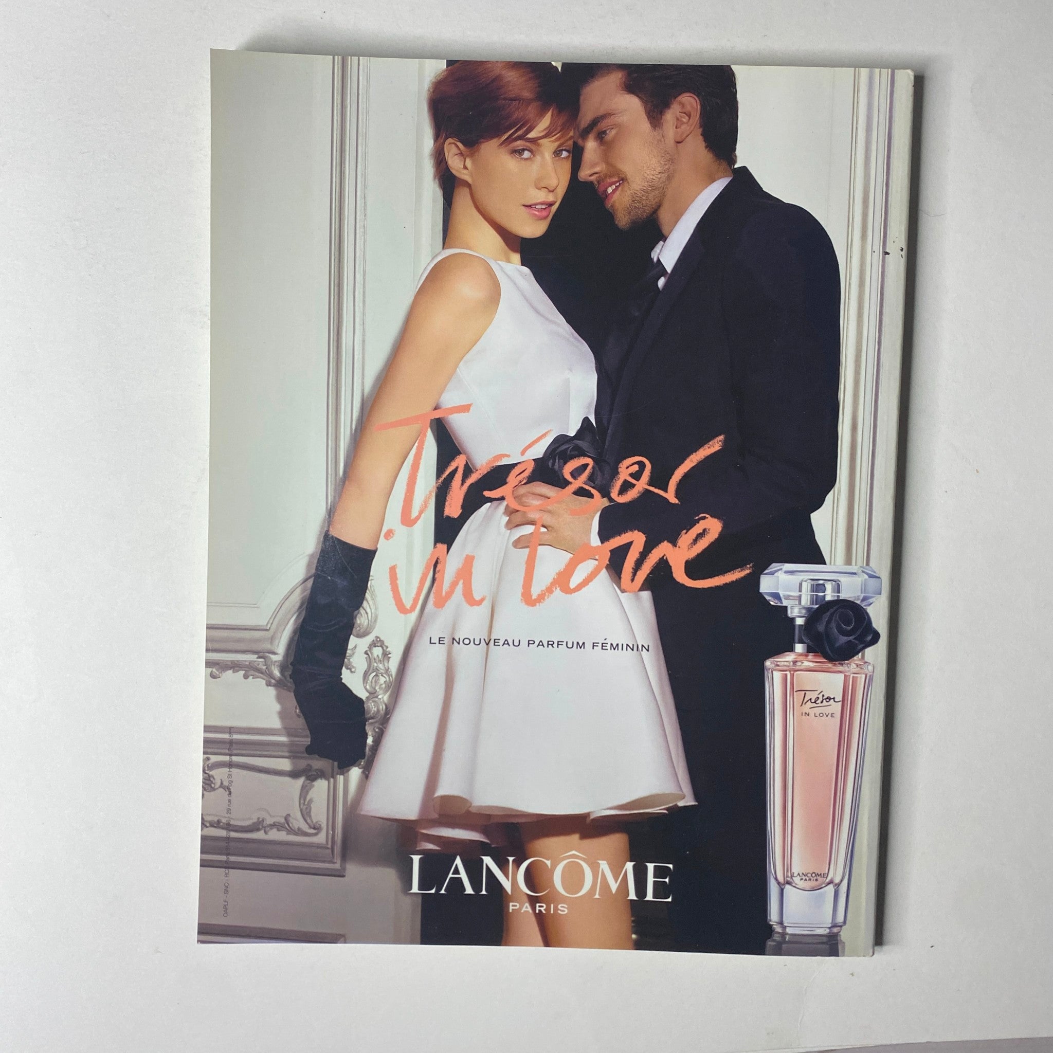 Advertisement from Vogue Paris Magazine June - July 2011 No. 918 for Lancôme's perfume, featuring a romantic couple.