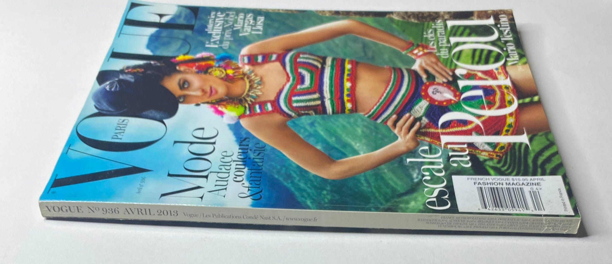 Side view of Vogue Paris Magazine April 2013 No. 936 showcasing Isabeli Fontana's colorful crochet ensemble on the cover, highlighting its features.