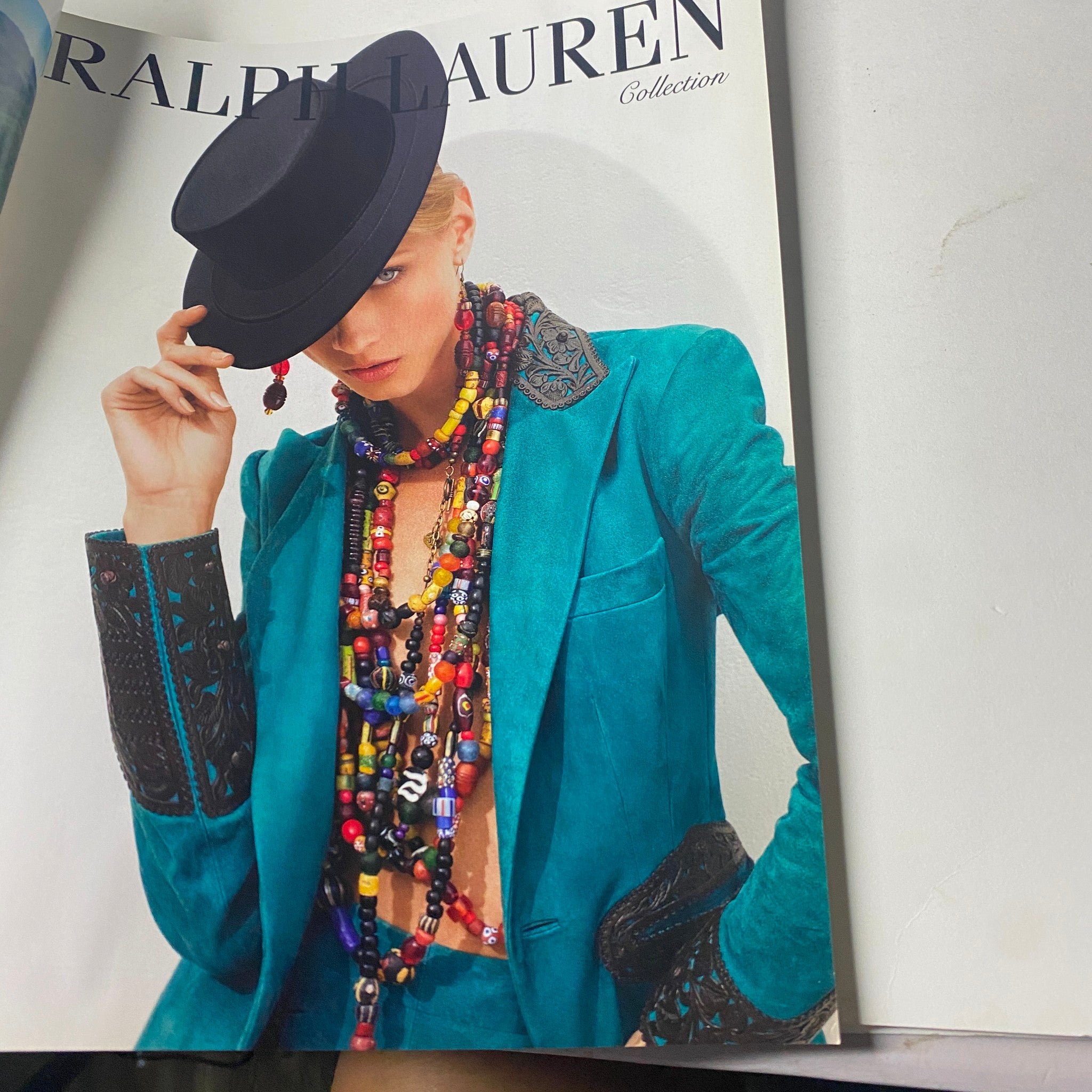 Another page from Vogue Paris Magazine April 2013 No. 936 featuring a Ralph Lauren advertisement, showcasing a model in a stylish hat and statement jewelry.
