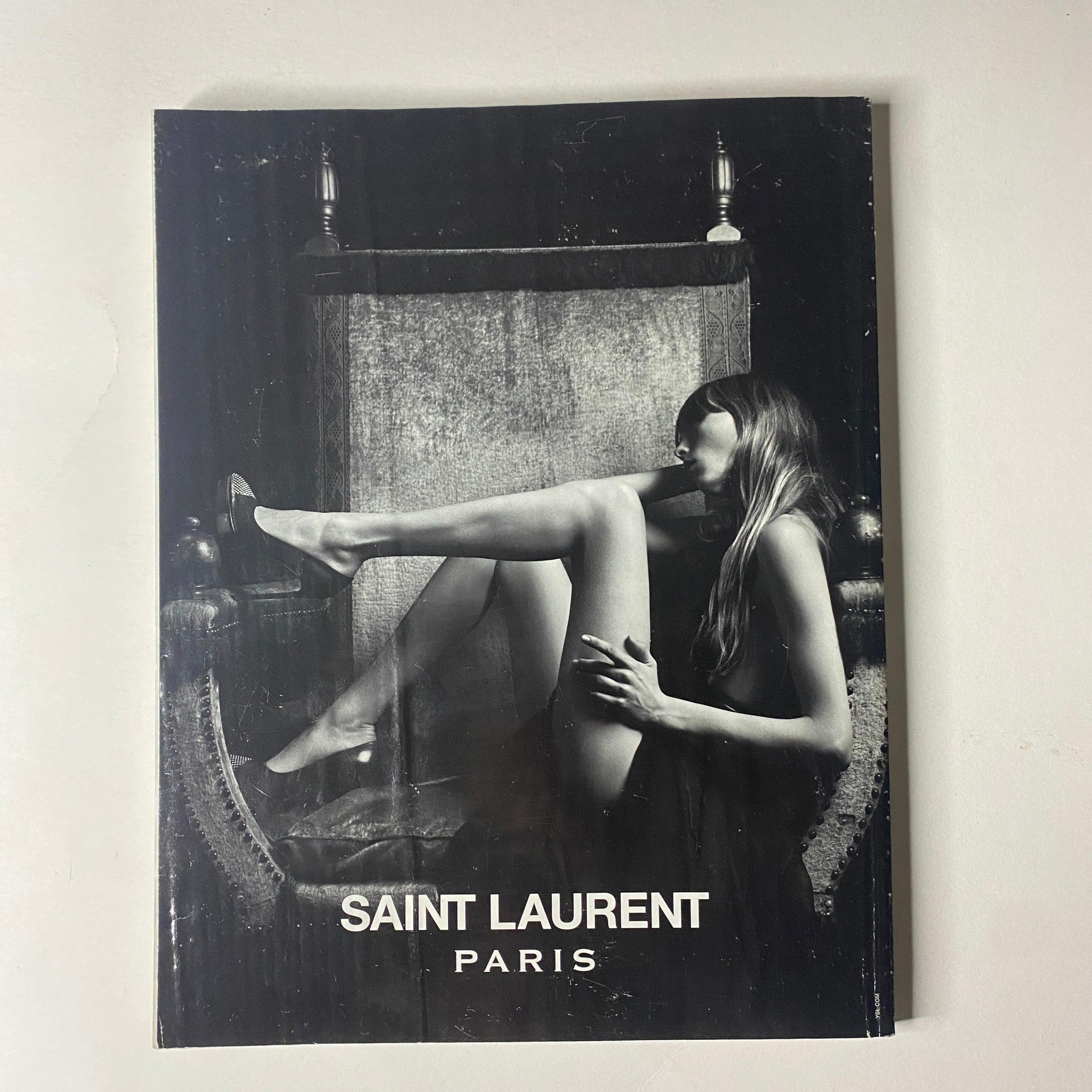 Saint Laurent Paris magazine cover featuring an artistic black and white photograph of a model elegantly posed, emphasizing the brand's chic aesthetic.