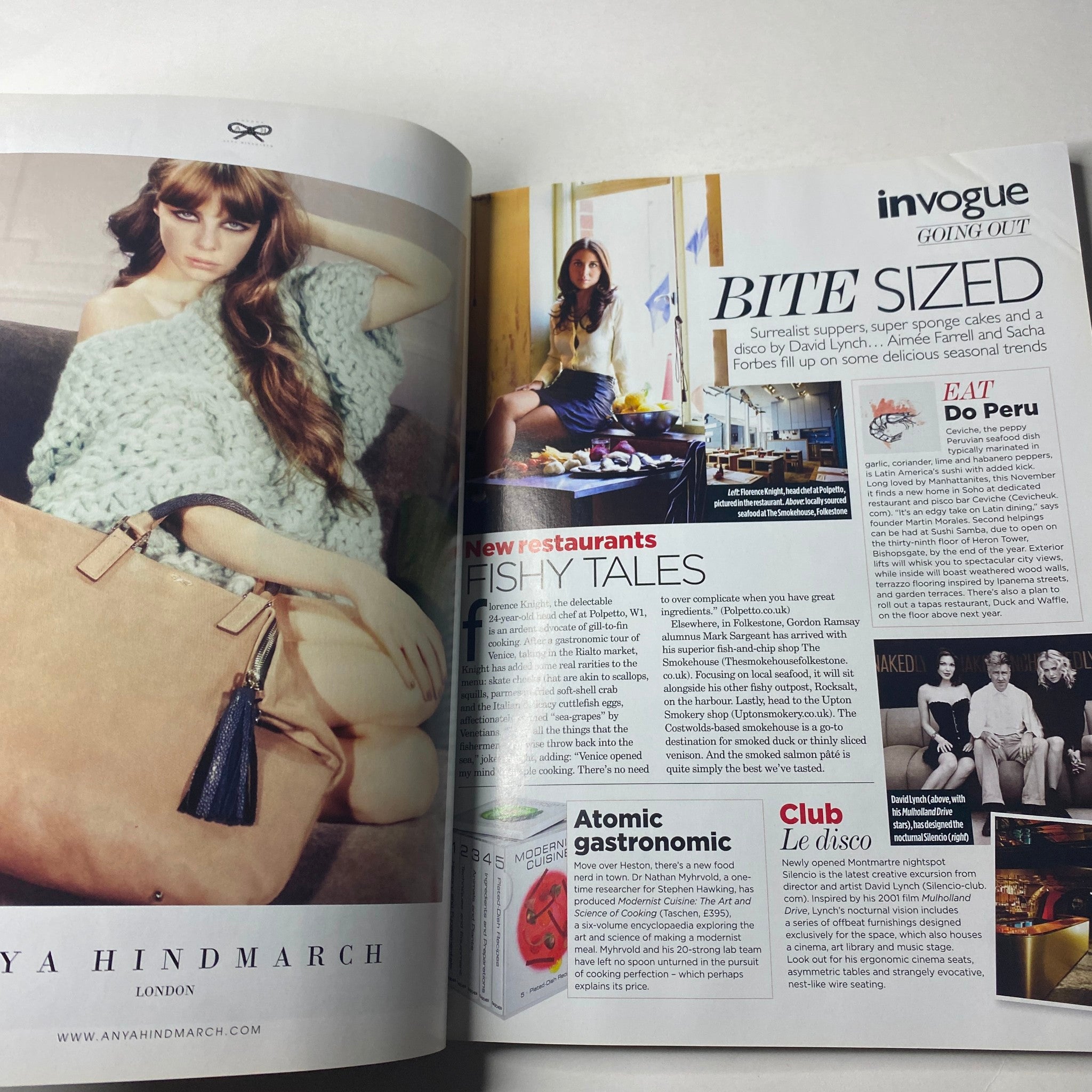 Inside page of Vogue British Magazine October 2011 featuring a model styled in a cozy oversized knit by designer Maya Hindmarch with a layout discussing notable restaurants and eating spots, titled 'Bite Sized'.