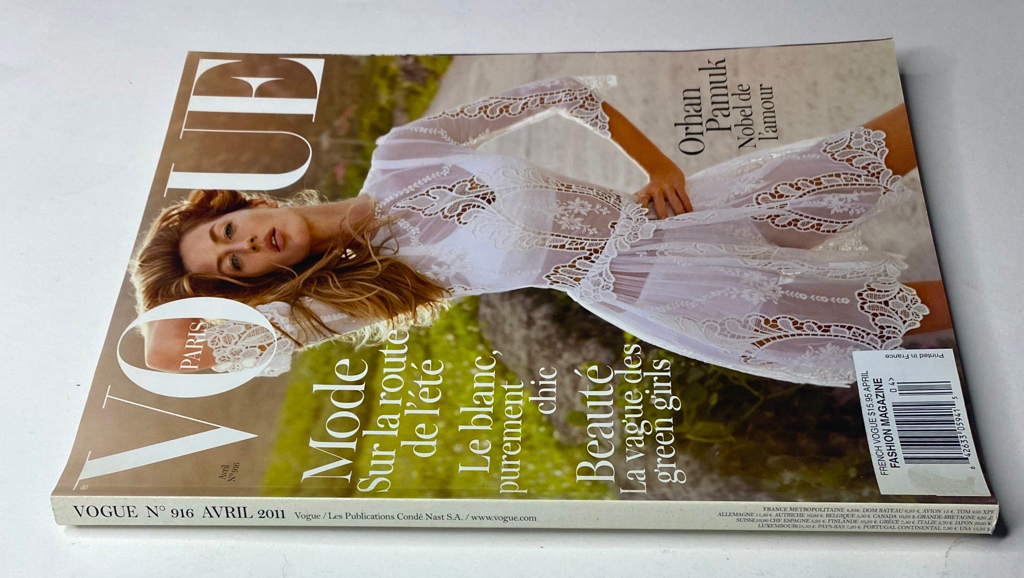 Back cover of Vogue Paris Magazine April 2011 No. 916 showcasing Gisele Bündchen in a white lace outfit, promoting fashion and beauty themes, no label, in very good condition.