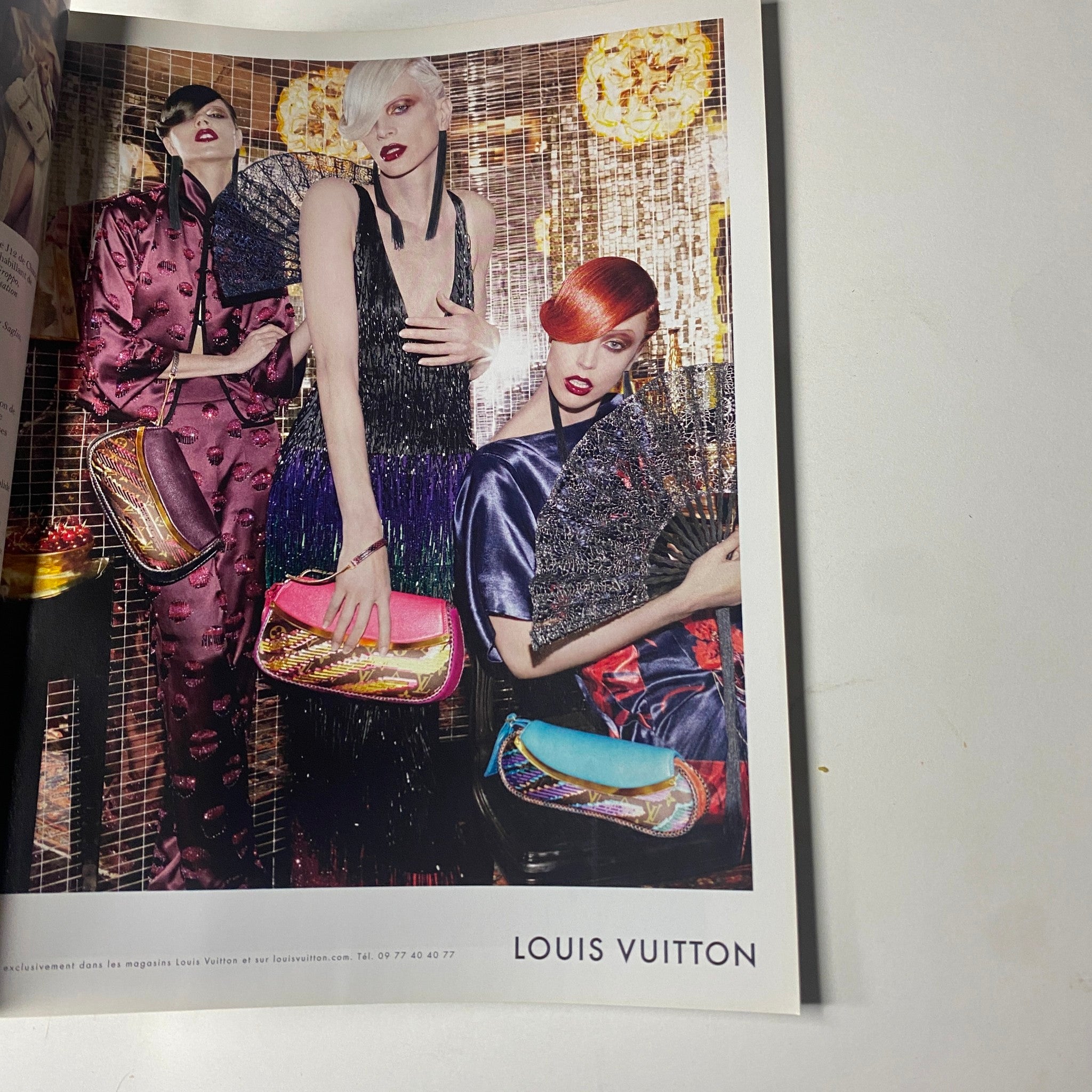 Louis Vuitton advertisement featuring three models in glamorous outfits, showcasing handbags, from the Vogue Paris Magazine April 2011 No. 916 Gisele Bündchen Cover.