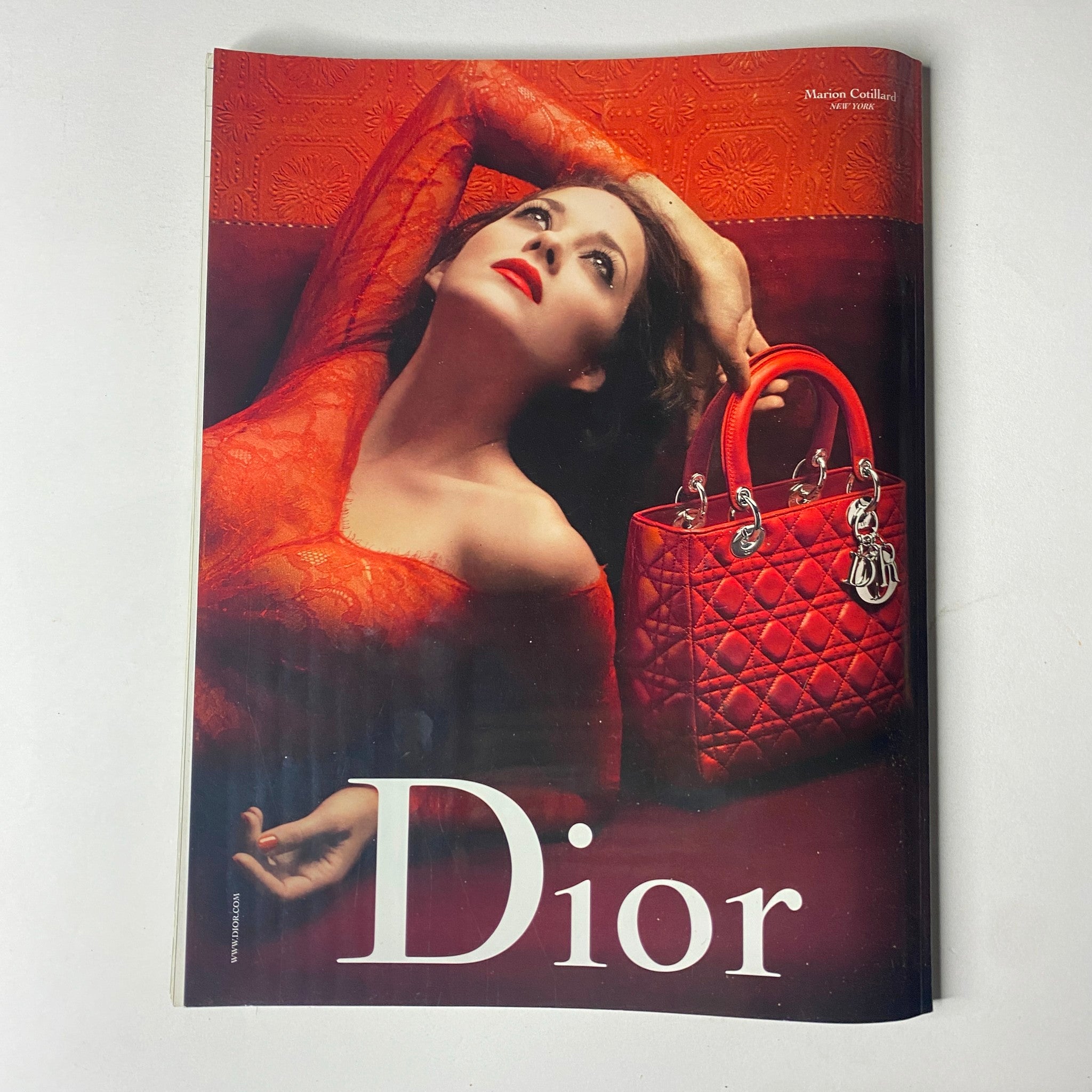 Cover image of Vogue Paris Magazine December 2009 featuring Laetitia Casta in a red outfit with a red Dior handbag, showcasing luxurious fashion photography.