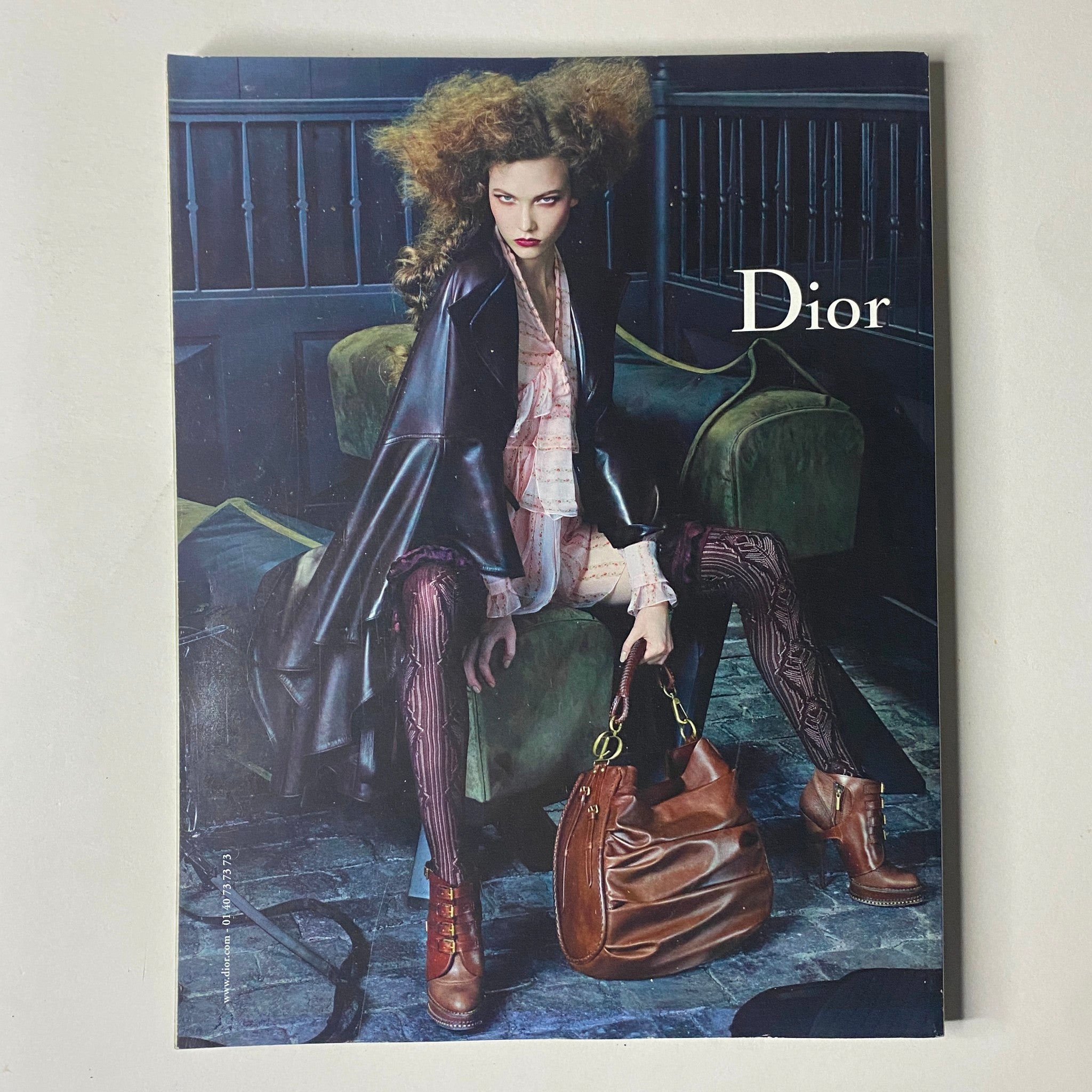 Cover of a fashion magazine featuring model Freja Beha Erichsen styled in Dior, wearing an edgy black coat and textured tights, embodying high-fashion aesthetics. Vogue Paris Magazine – August 2010 No. 909.