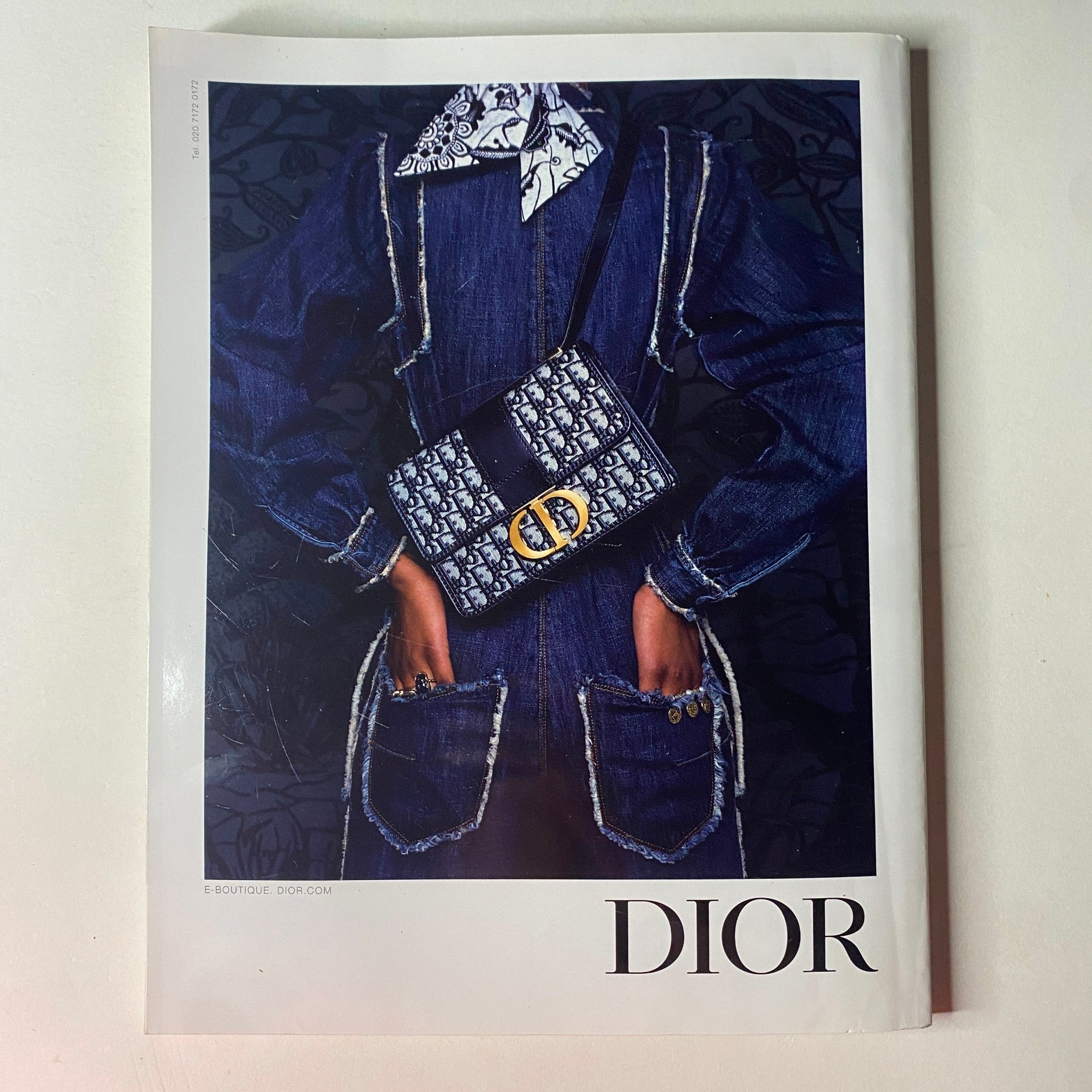 Cover of Dior magazine featuring a model wearing a stylish outfit with a prominent Dior handbag, emphasizing high fashion trends from Vogue British Magazine November 2019.