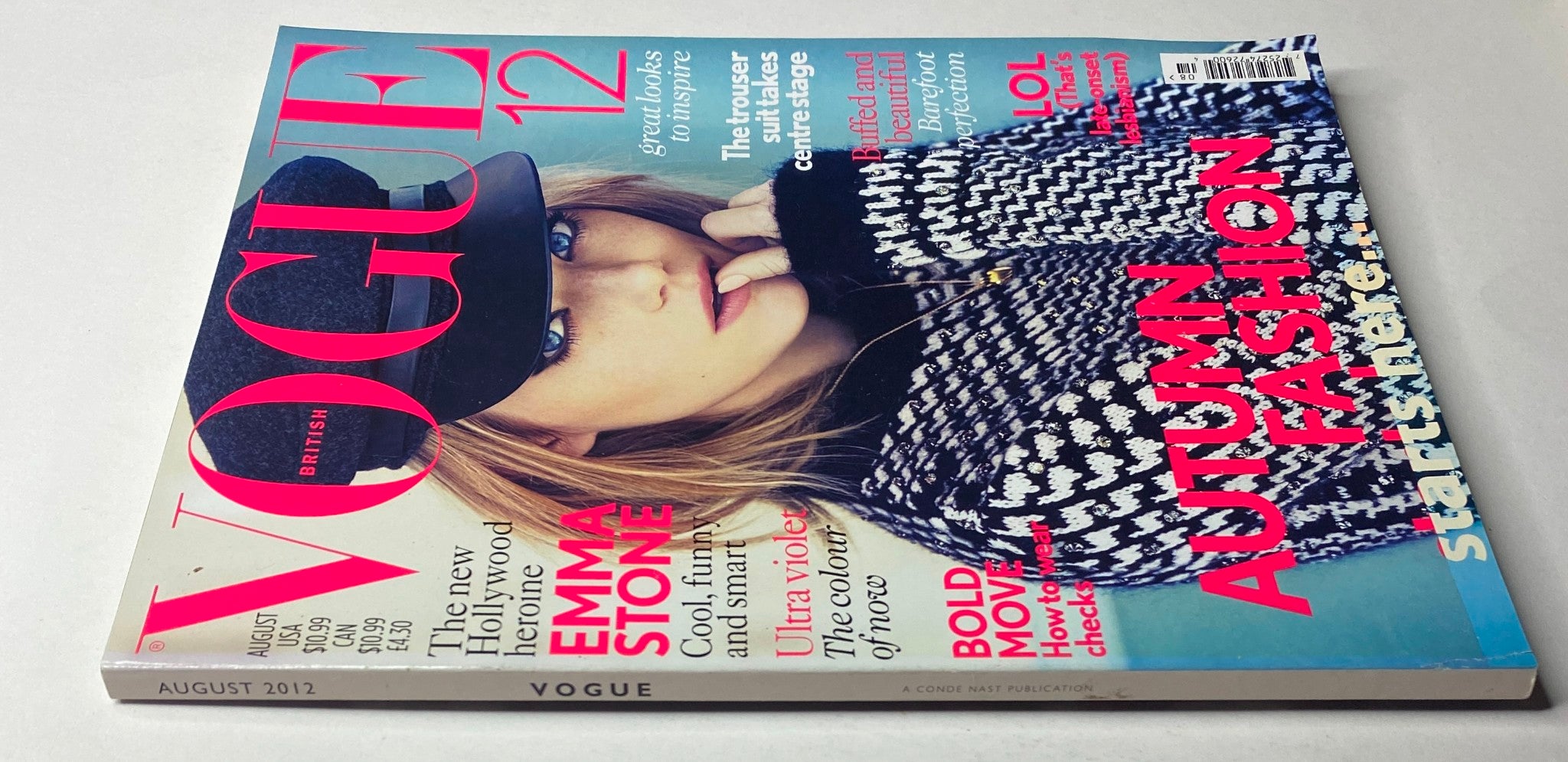 Close-up view of Vogue British Magazine August 2012 Emma Stone Cover No Label VG, featuring striking colors and designs, emphasizing Emma Stone's fashion-forward look.