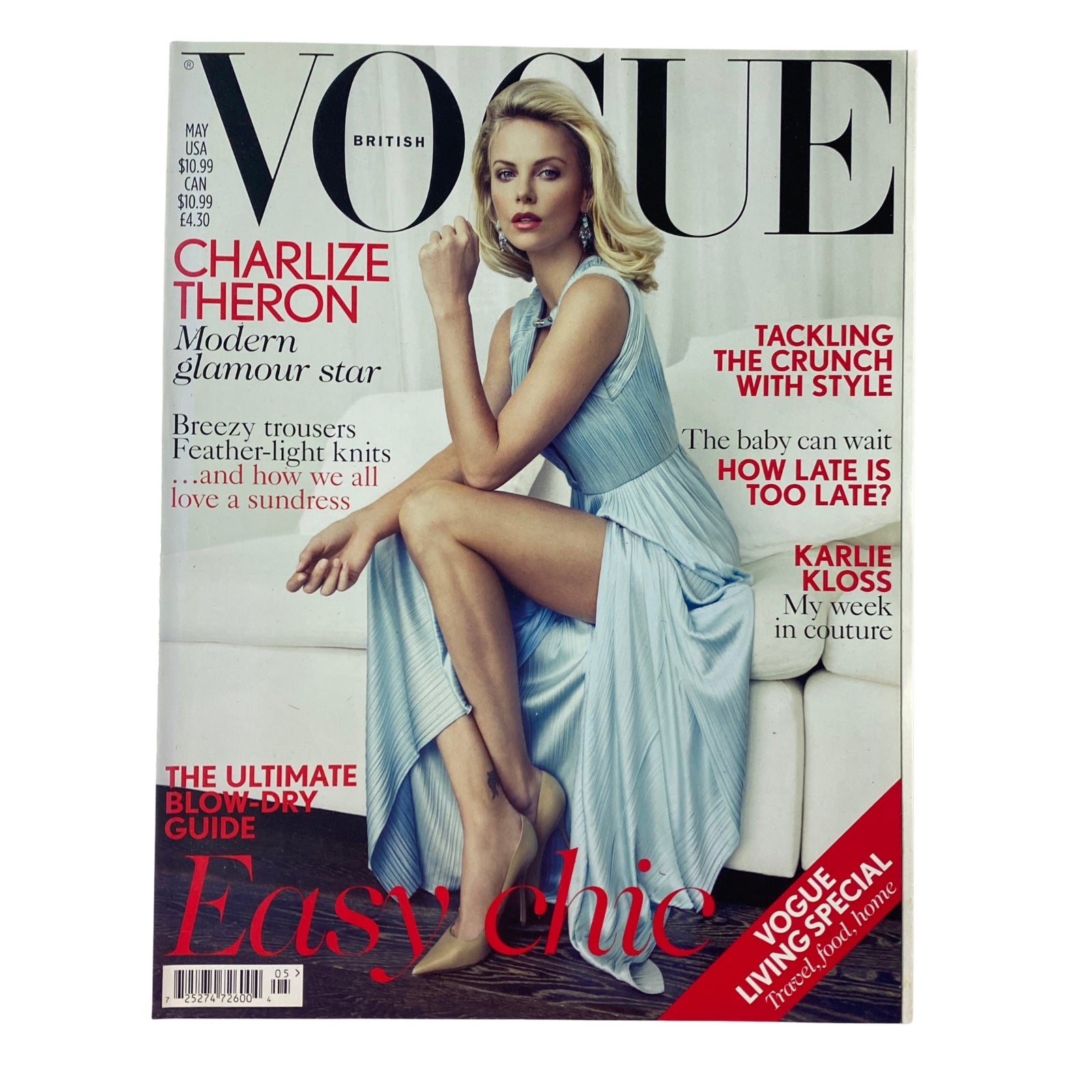 Cover of Vogue British Magazine May 2012 featuring Charlize Theron, showcasing modern glamour with a silky light blue dress and elegant style.