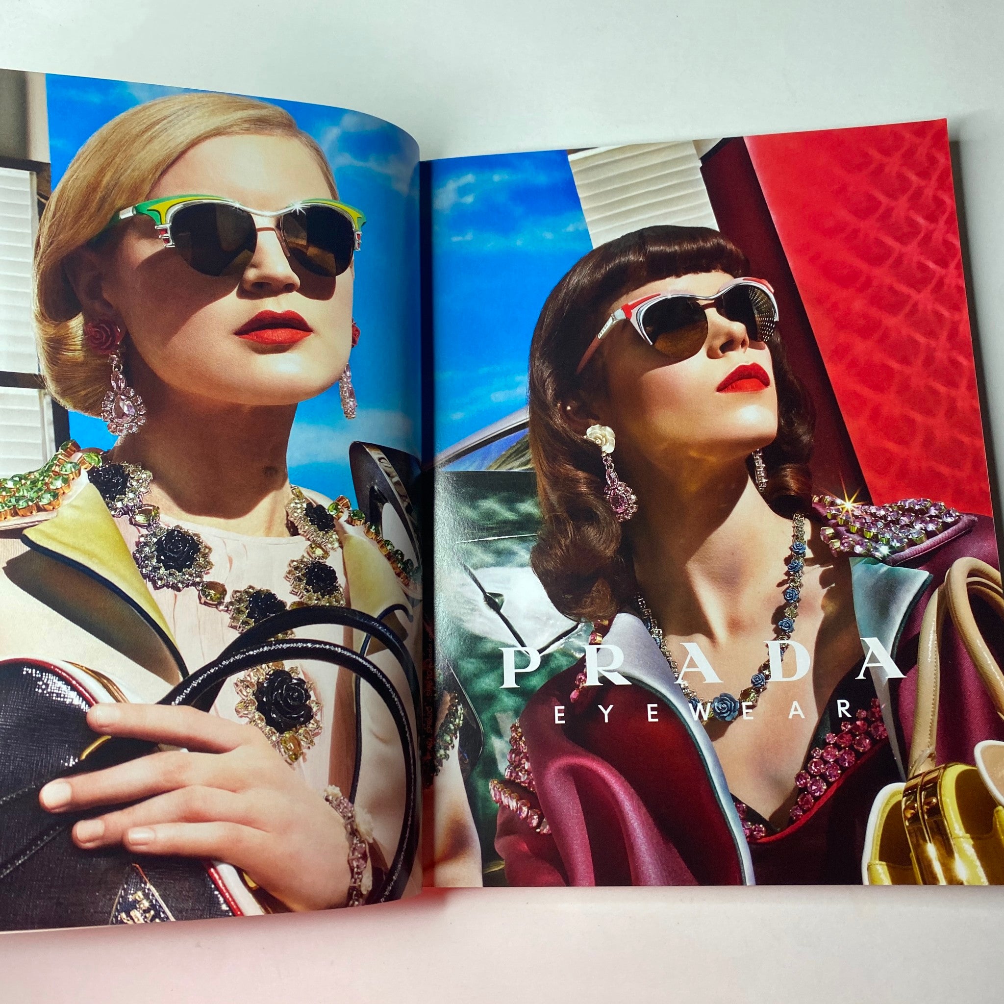 Prada Eyewear advertisement featuring two models wearing colorful sunglasses, showcasing high-fashion eyewear designs from Vogue British Magazine May 2012 Charlize Theron Cover No Label VG.
